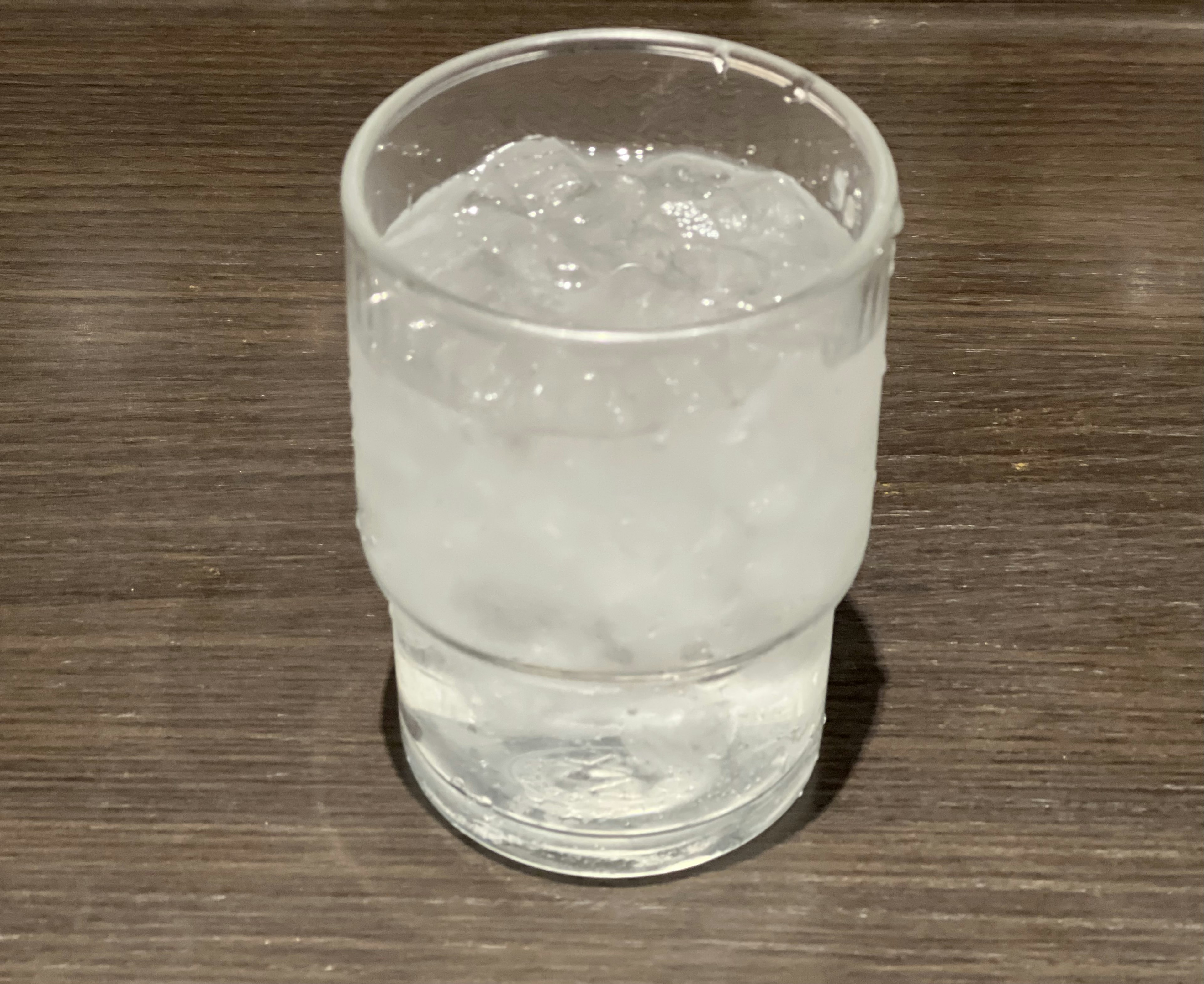 A clear glass filled with ice and water