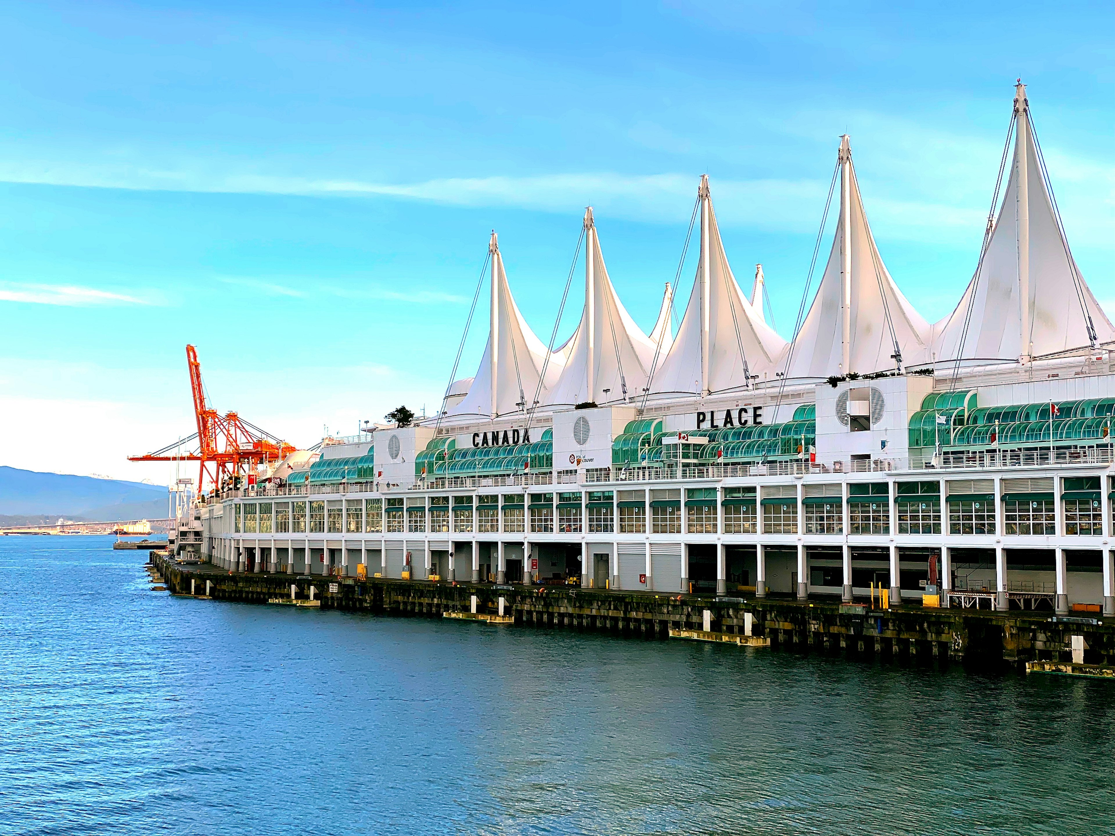 Vancouver's Canada Place with distinctive white tent roofs and the blue waterfront