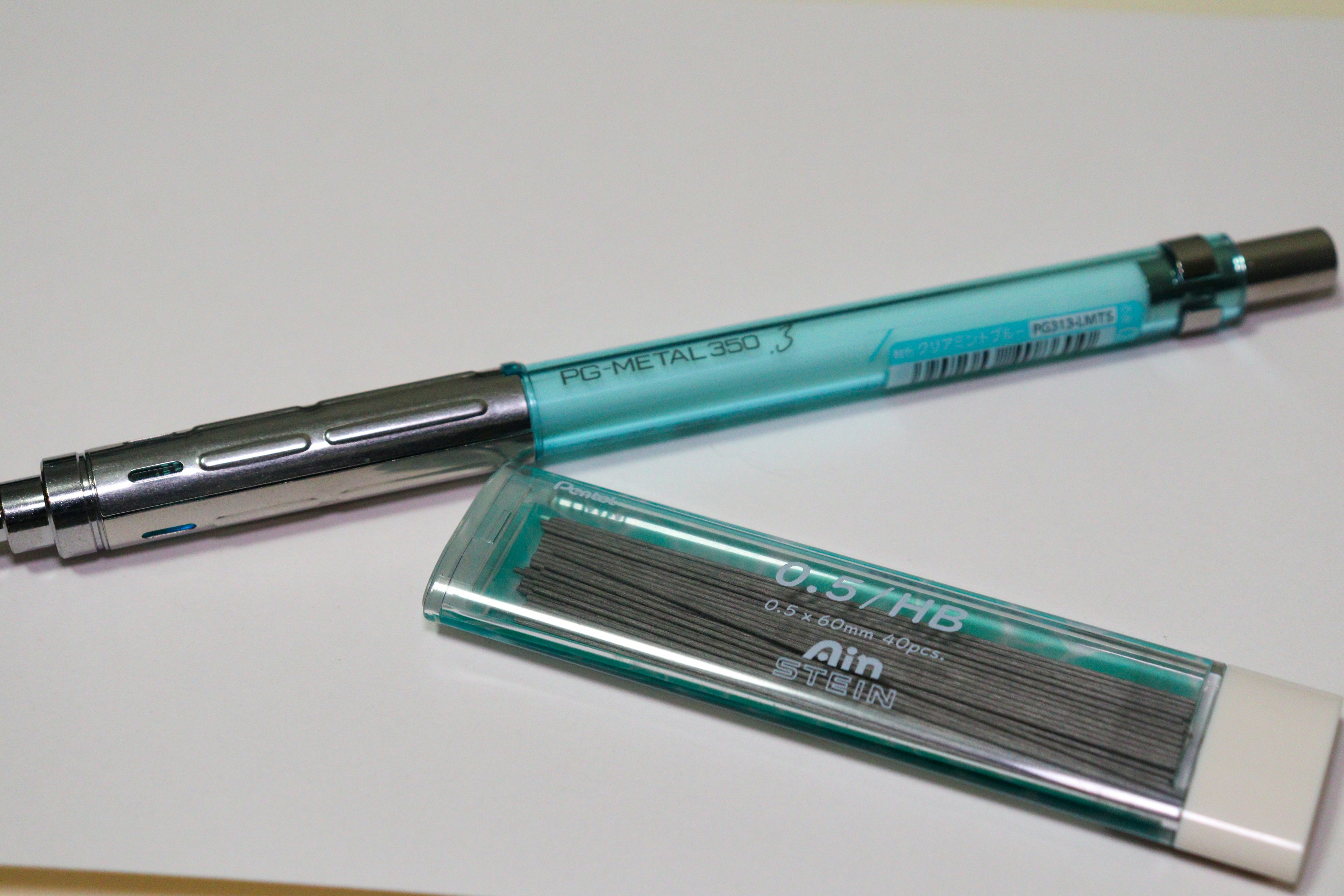 A blue body mechanical pencil and an eraser placed on a white background