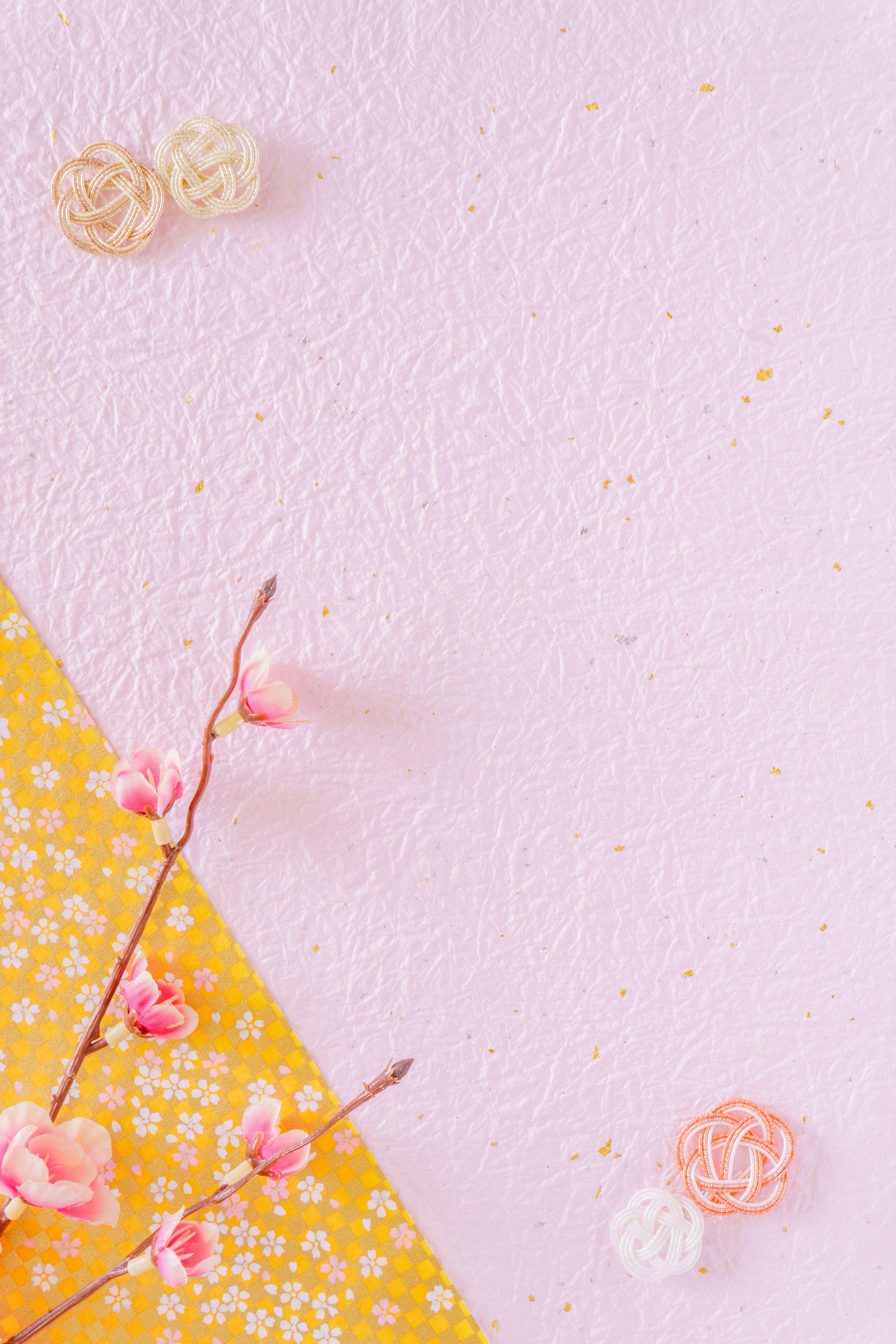 Soft pink background with yellow texture and small flower decorations