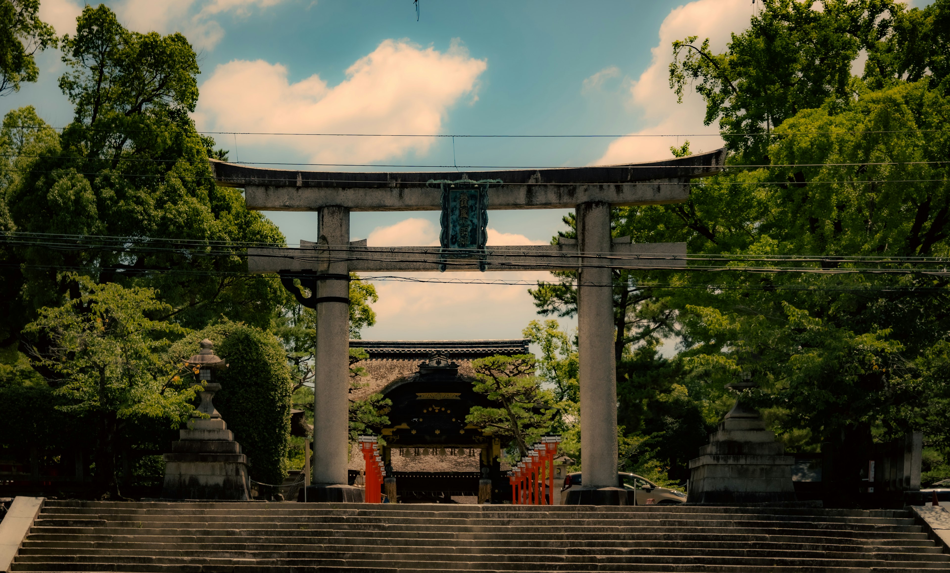 Aussicht auf ein Torii und Stufen eines Schreins unter einem blauen Himmel