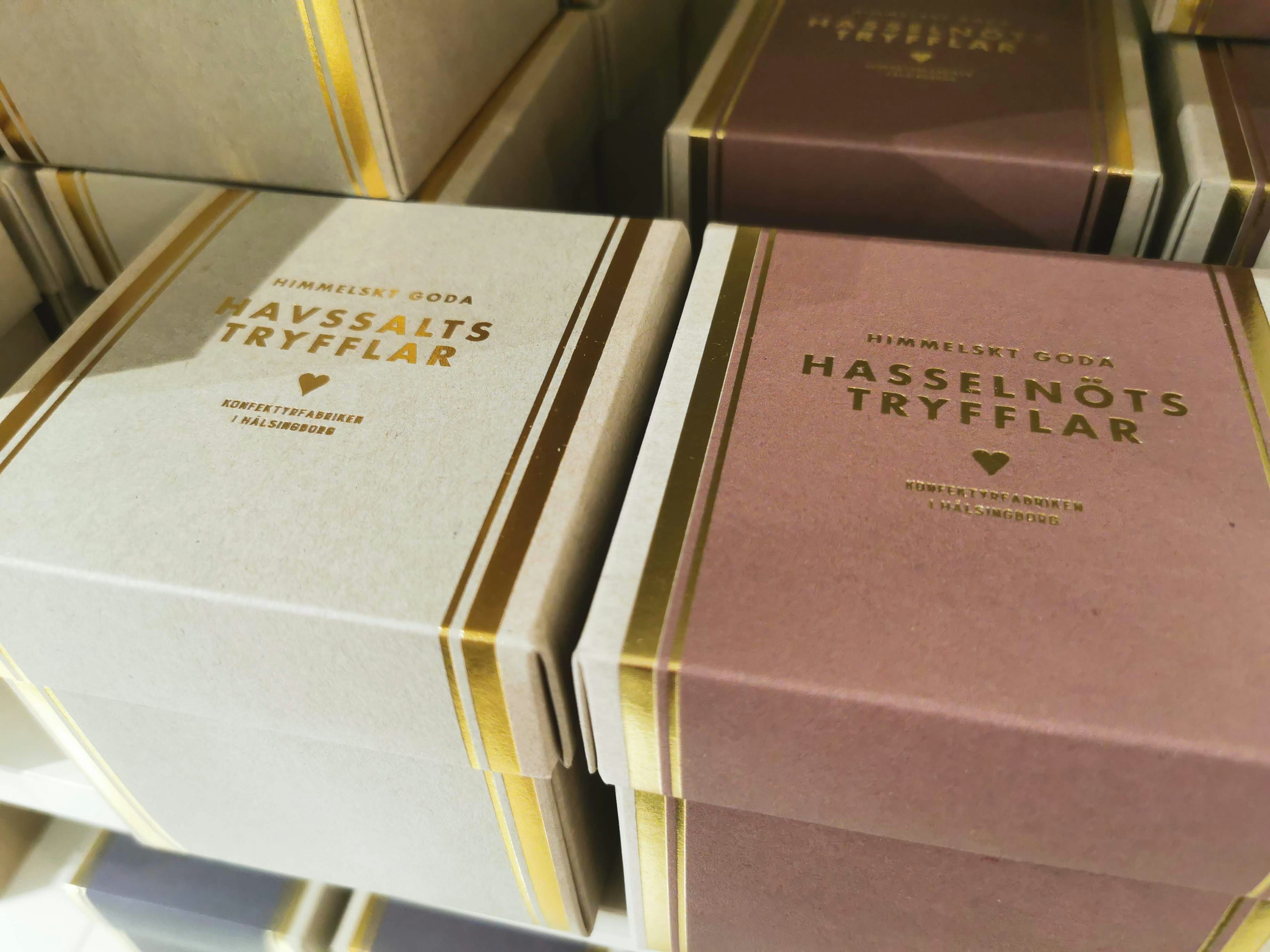 White and brown truffle boxes arranged on a shelf