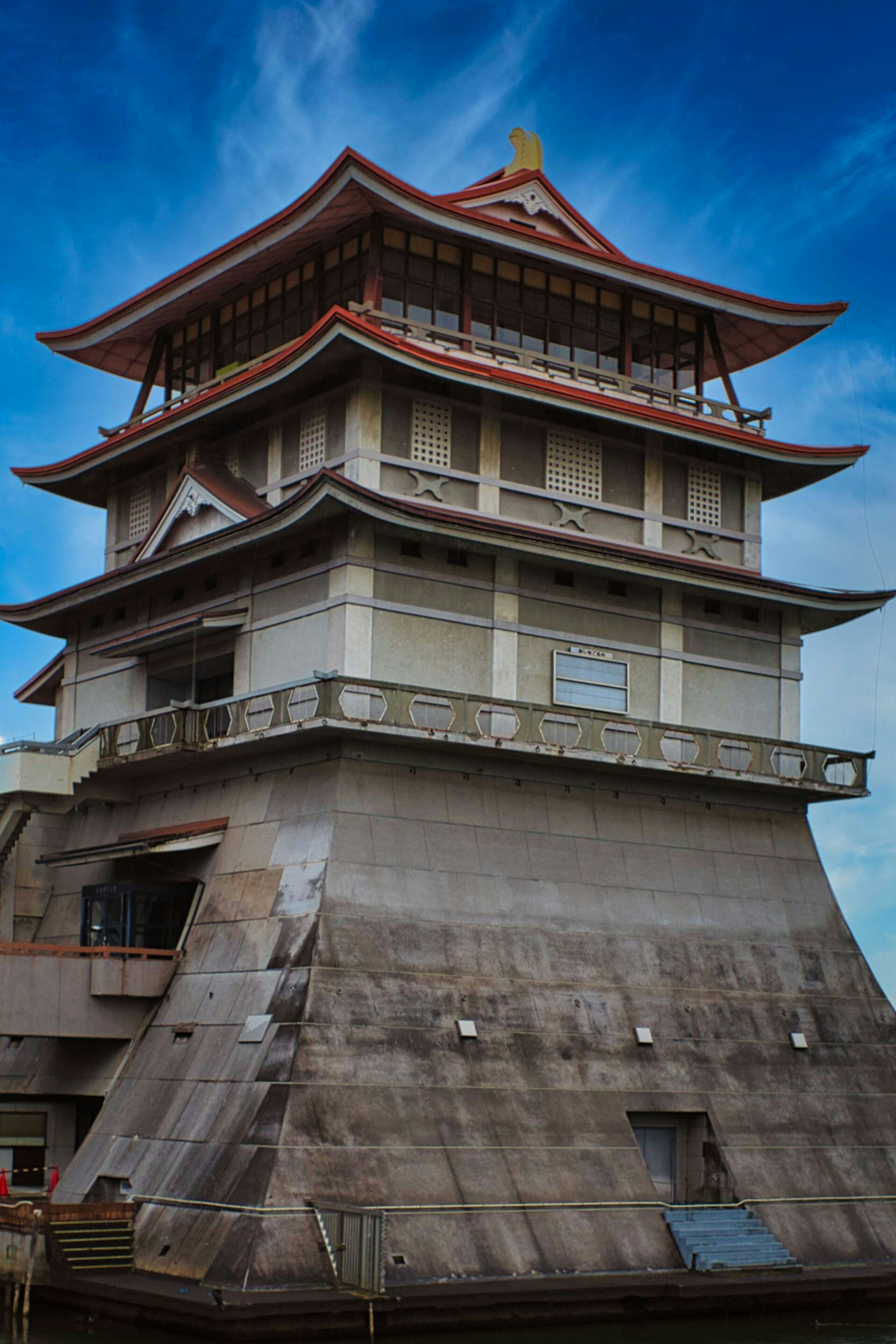 A distinctive multi-layered tower standing under a blue sky