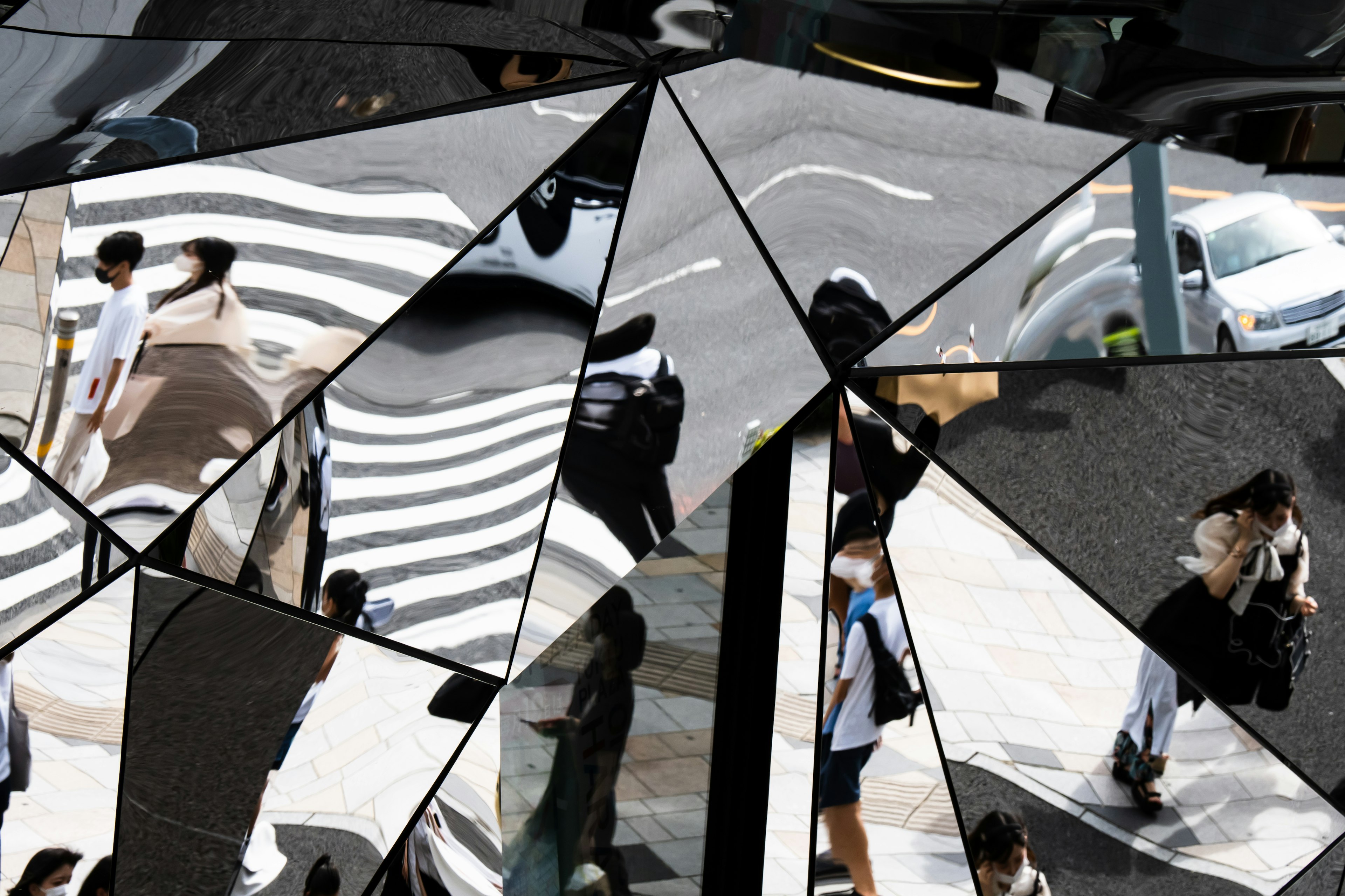 Abstract collage of reflections featuring people and striped crosswalks