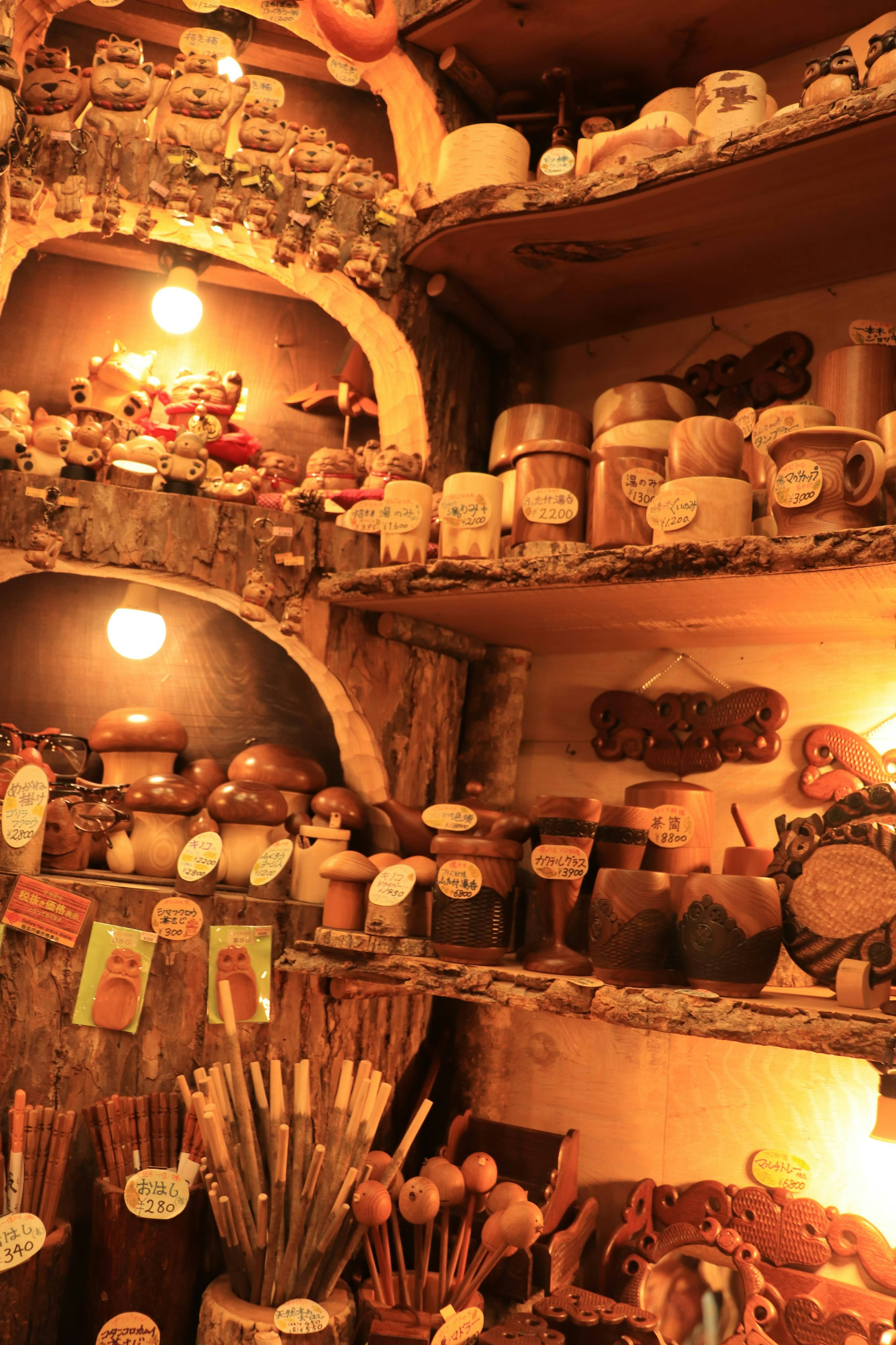 Warm-toned wooden shelves filled with pottery and tools collection