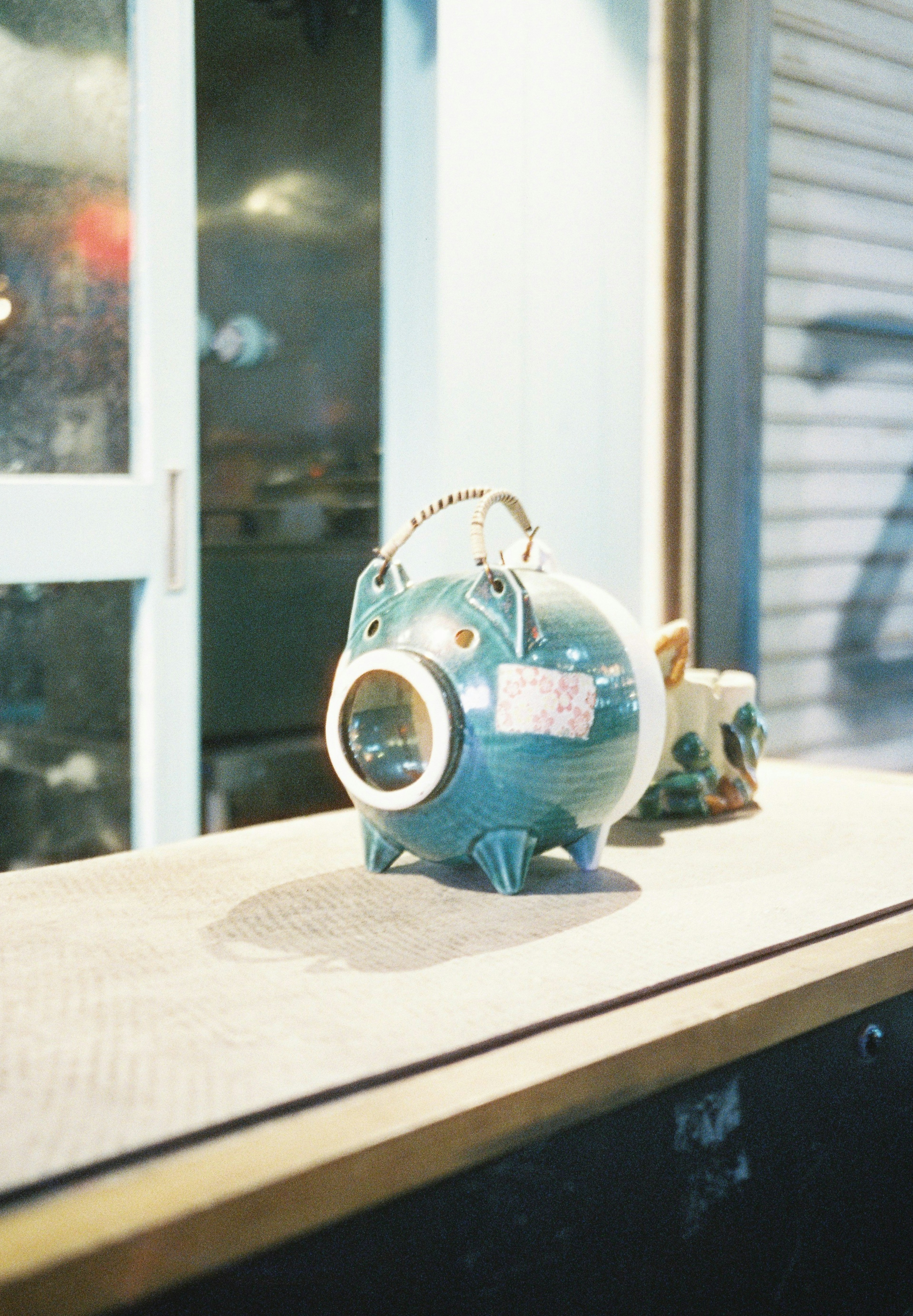 A blue ceramic piggy bank placed on a table