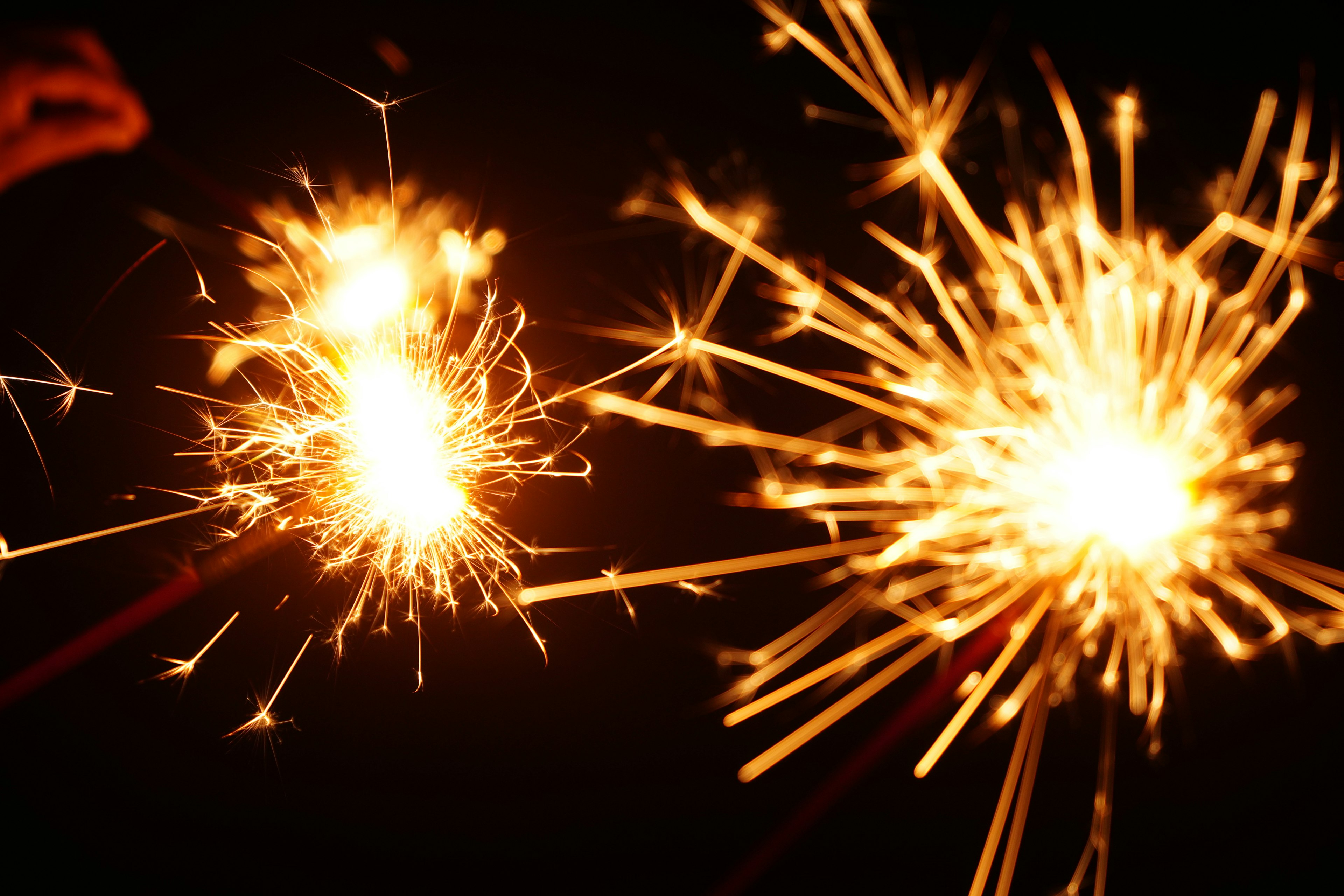 Two sparklers glowing in the night