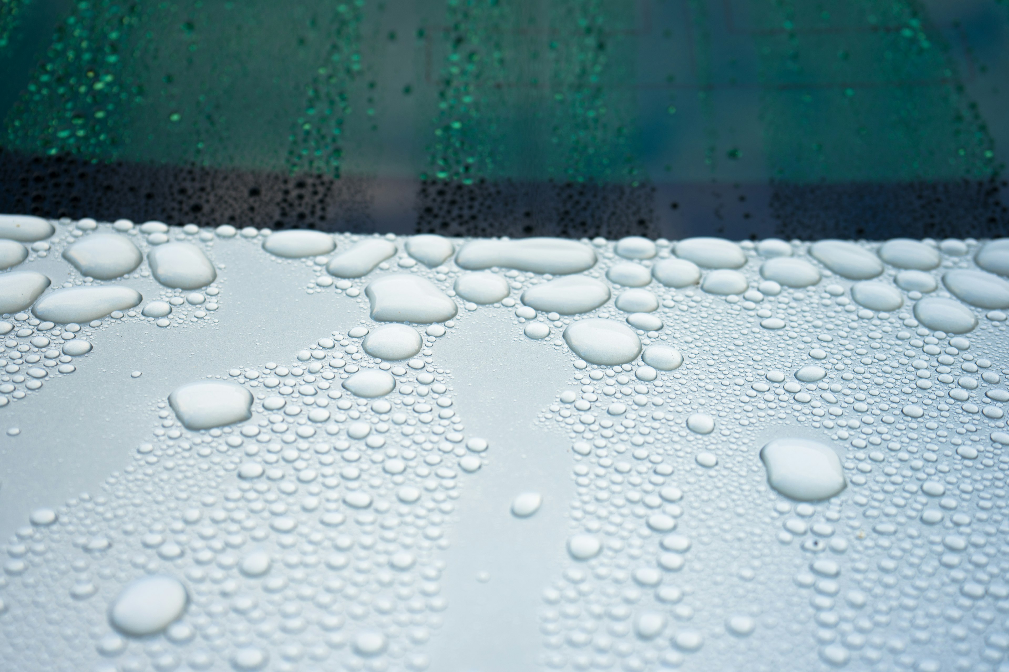 Close-up of water droplets on a white surface