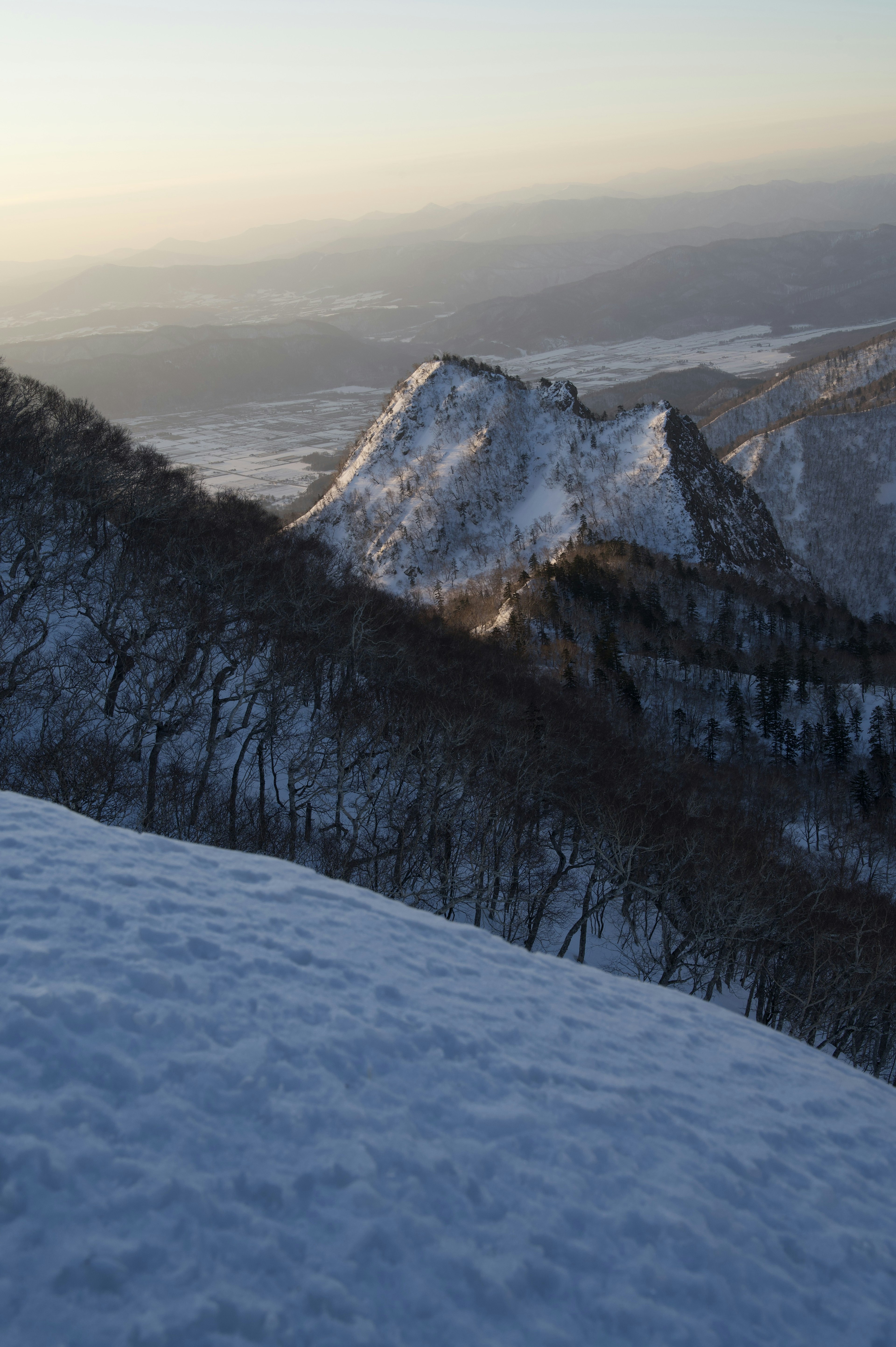 Snow-covered mountain landscape with sunlight streaming through