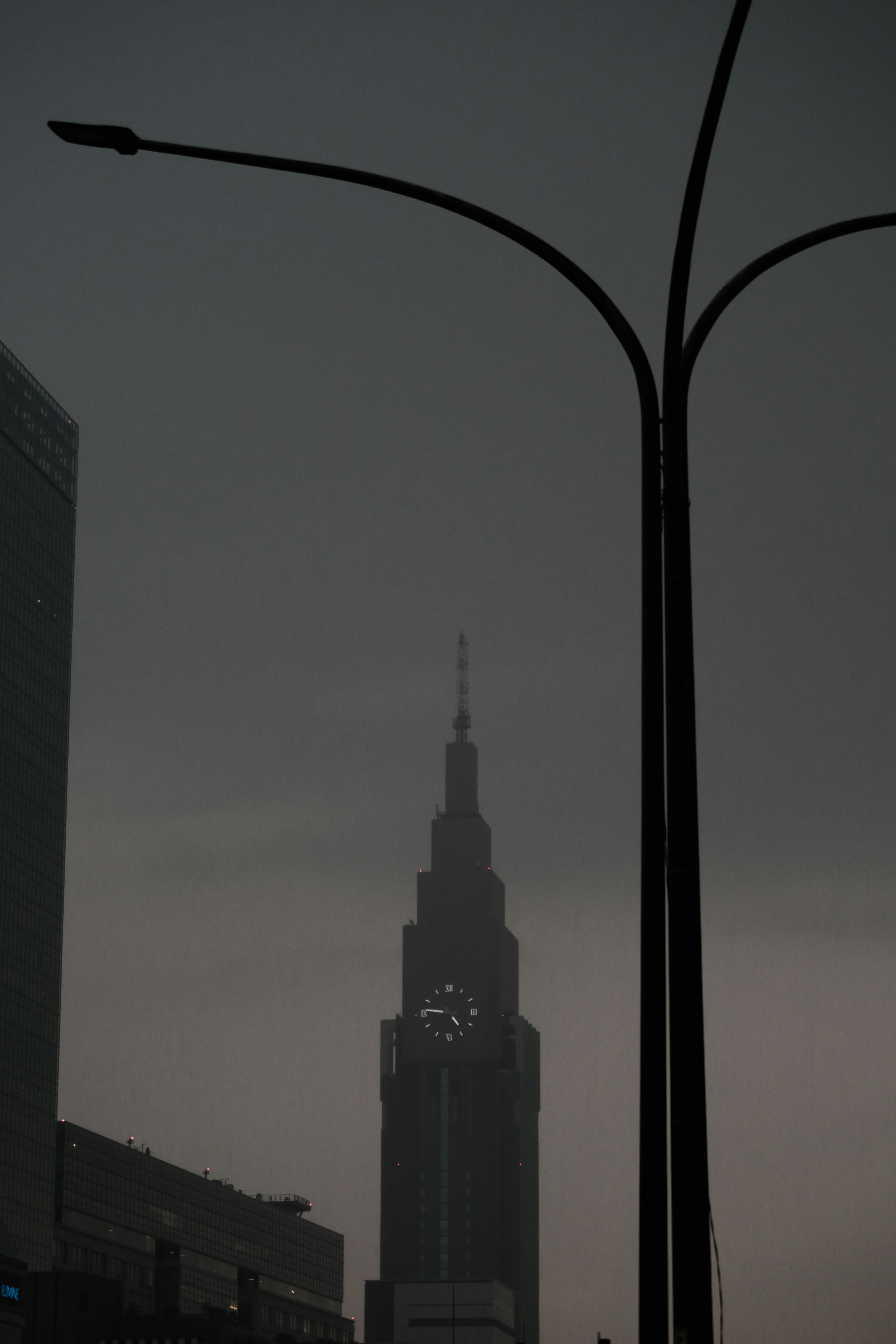 Silhouette of the Empire State Building against a dark sky with streetlights