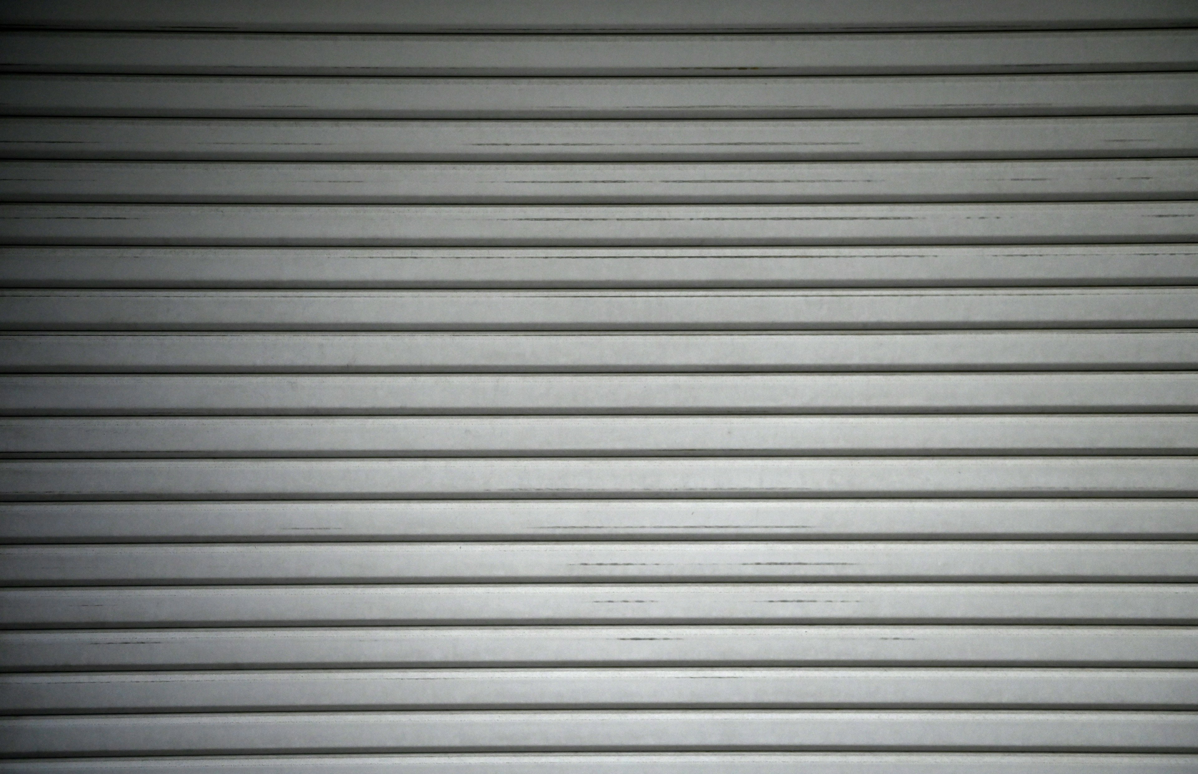 Gray metal roller shutter with horizontal stripes