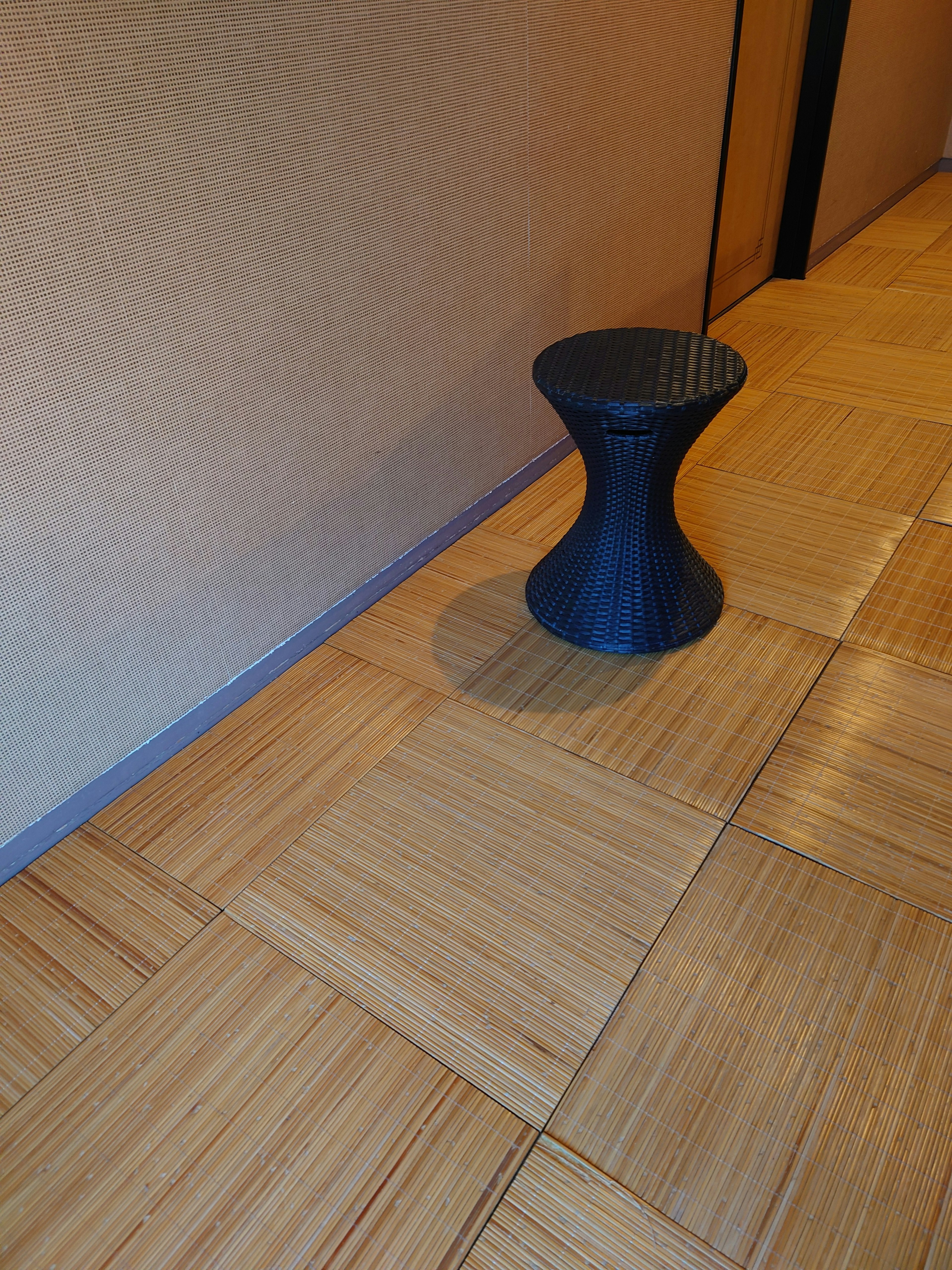 Interior featuring a black stool and wooden patterned flooring