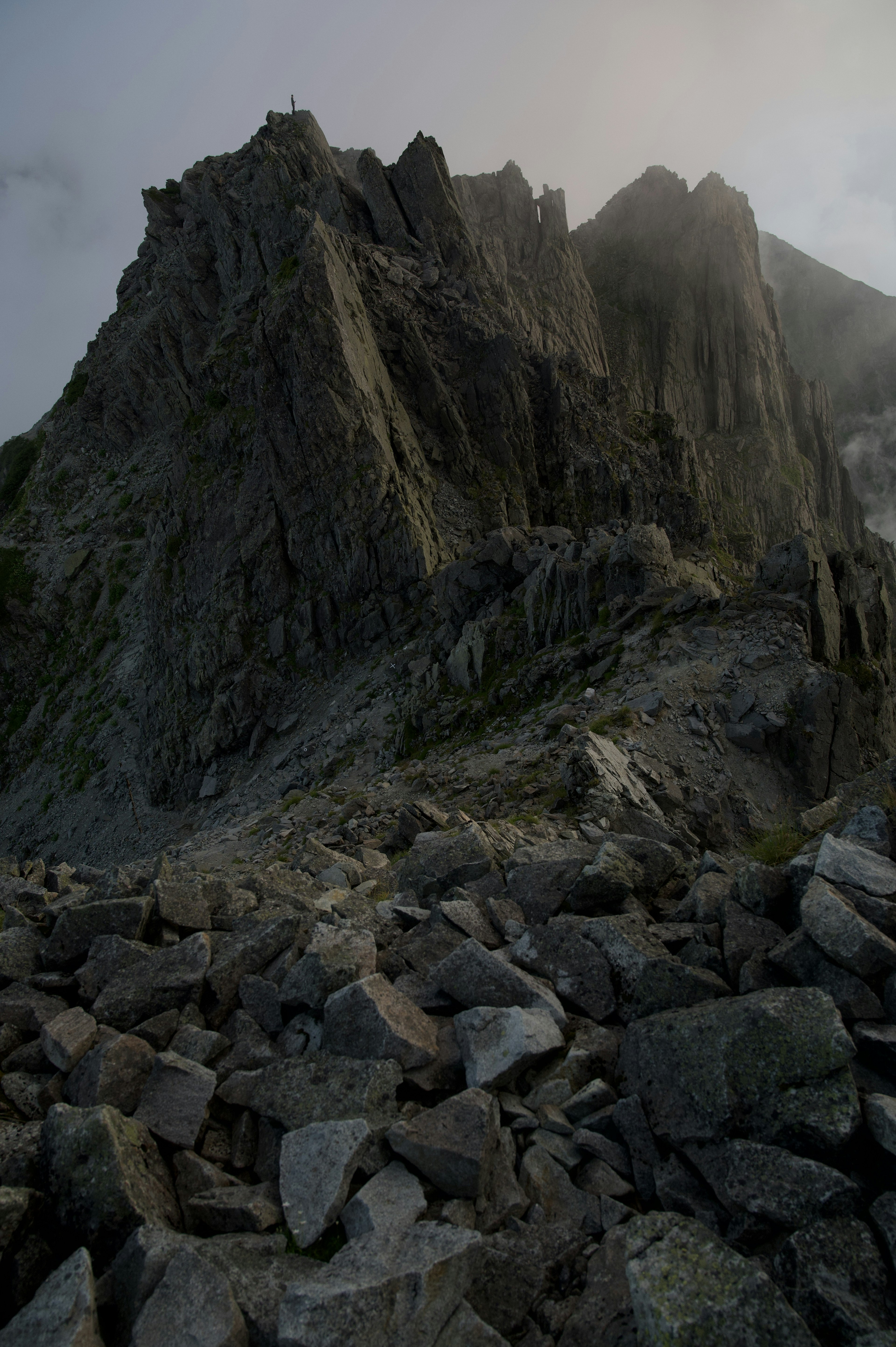 Rugged mountain landscape surrounded by rocks and mist