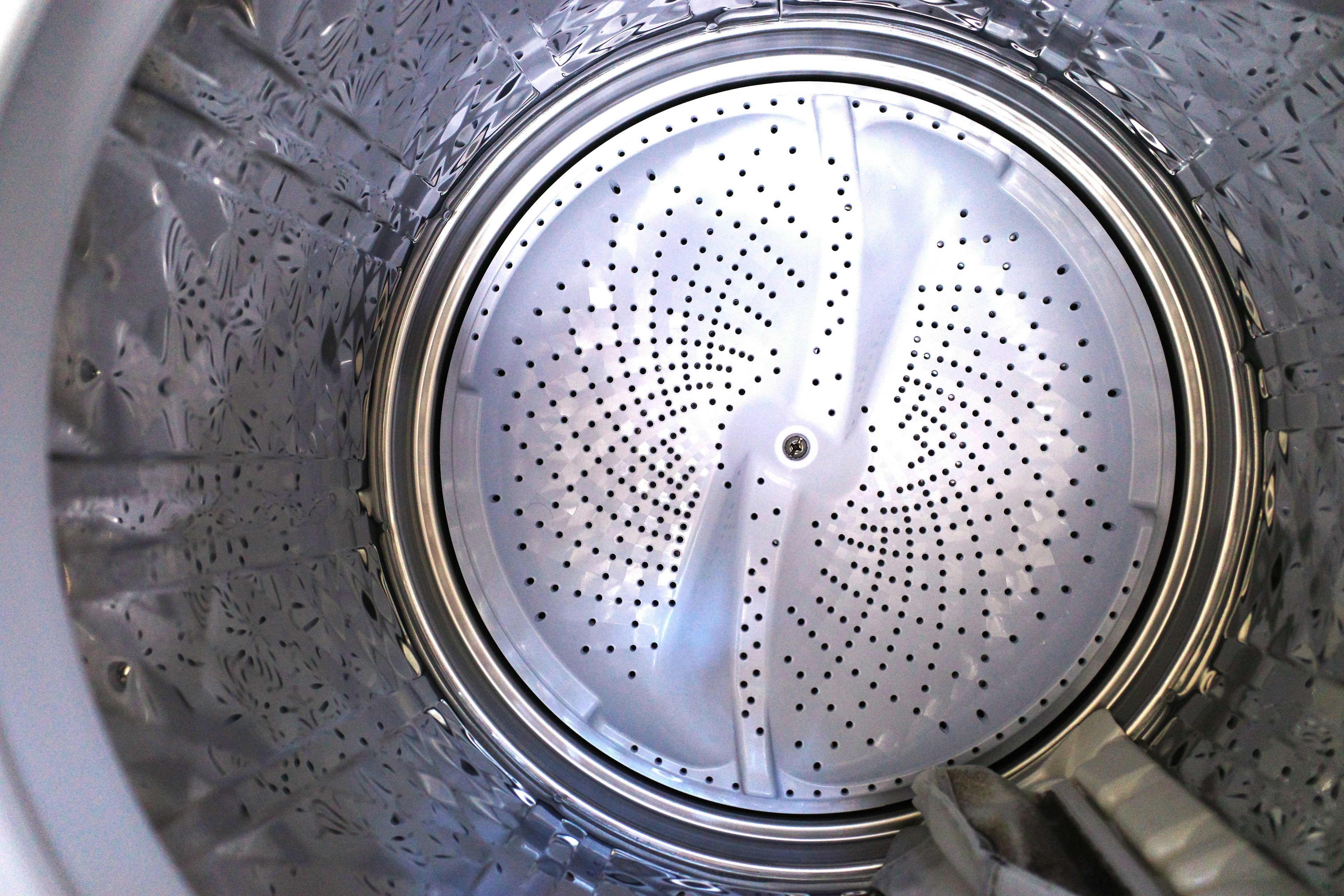 Detailed view of a washing machine's metal drum interior