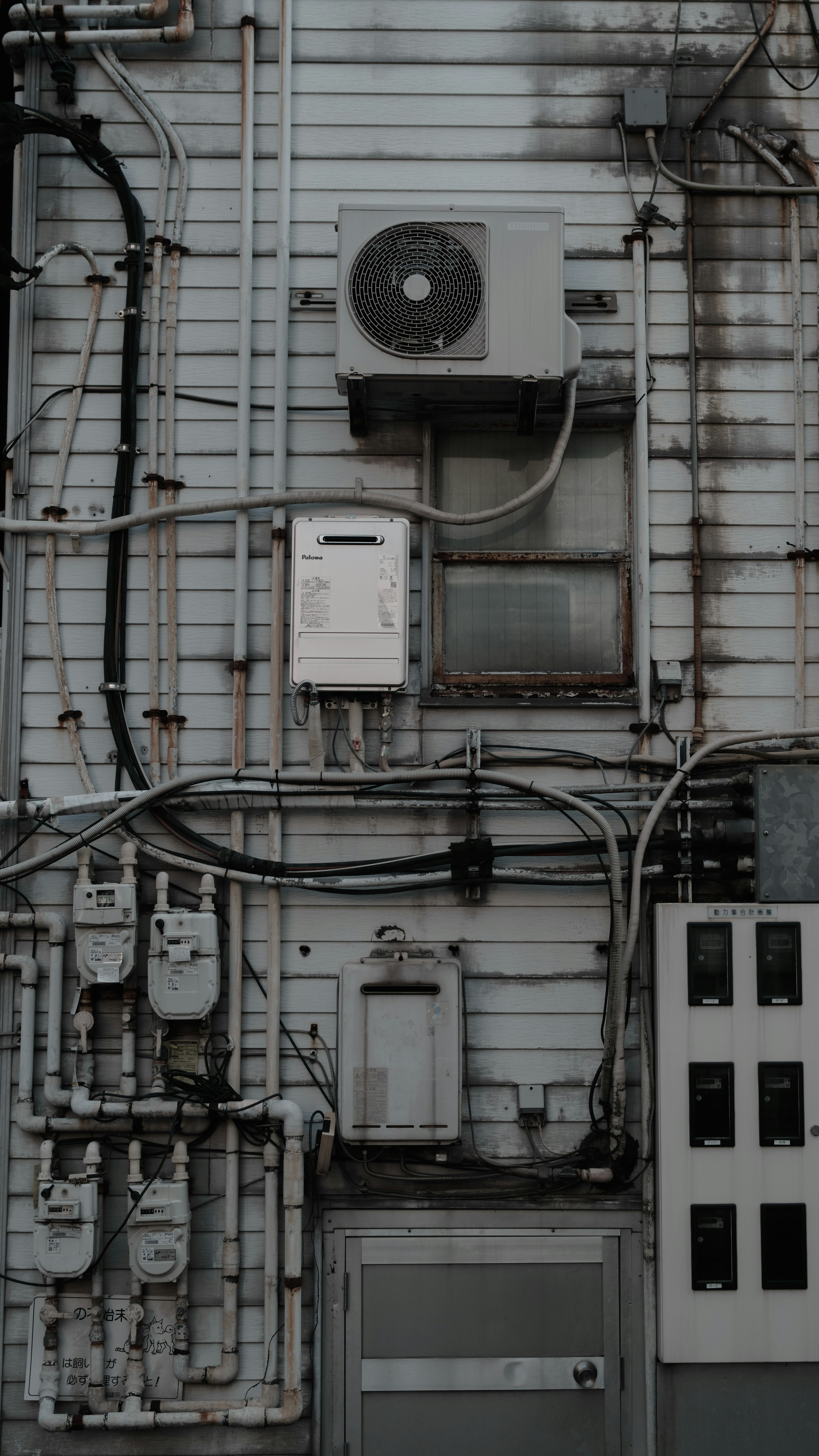 Detailed view of an air conditioning unit and wiring on a wall