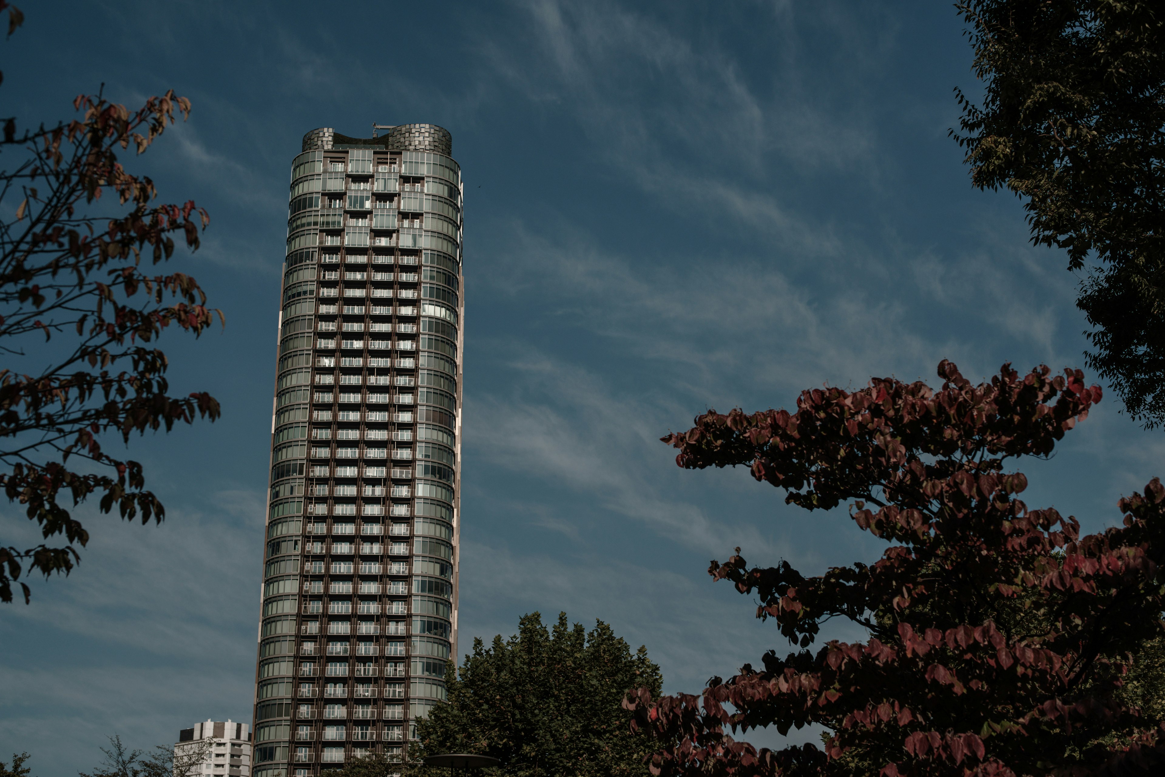 Tall building against a blue sky with clouds