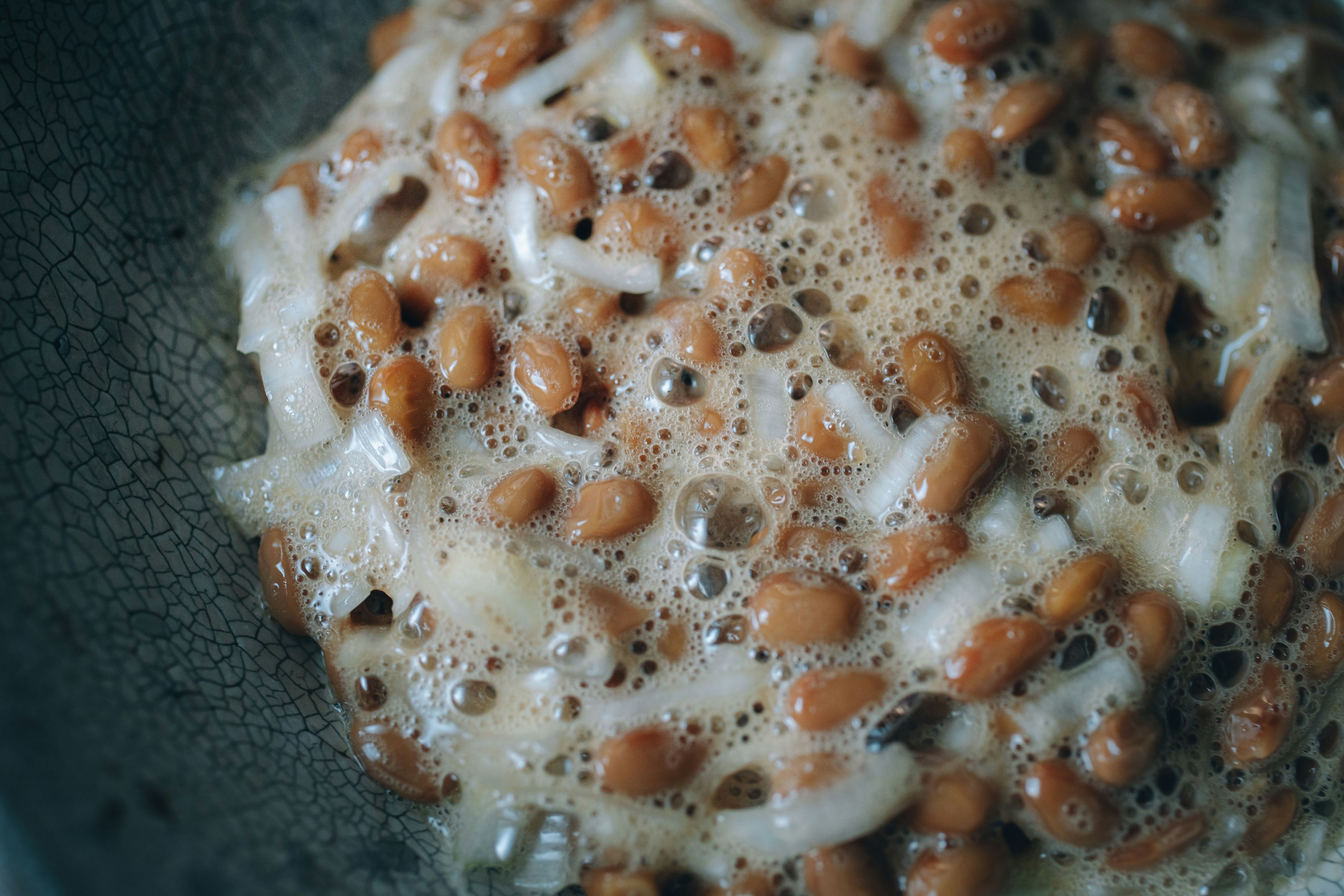 Primer plano de natto burbujeante mezclado con arroz blanco