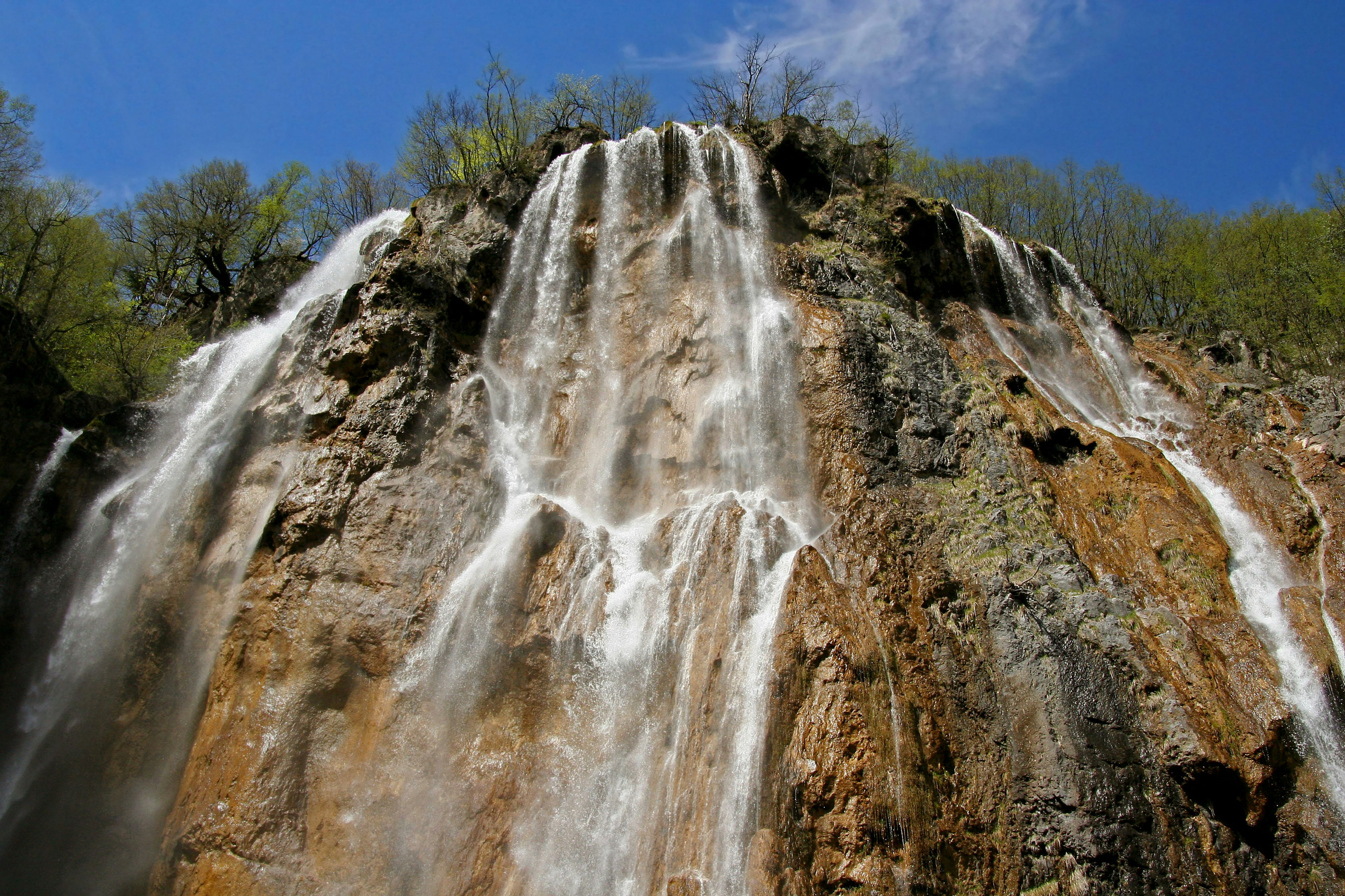 A beautiful scene of a waterfall cascading down rocky cliffs