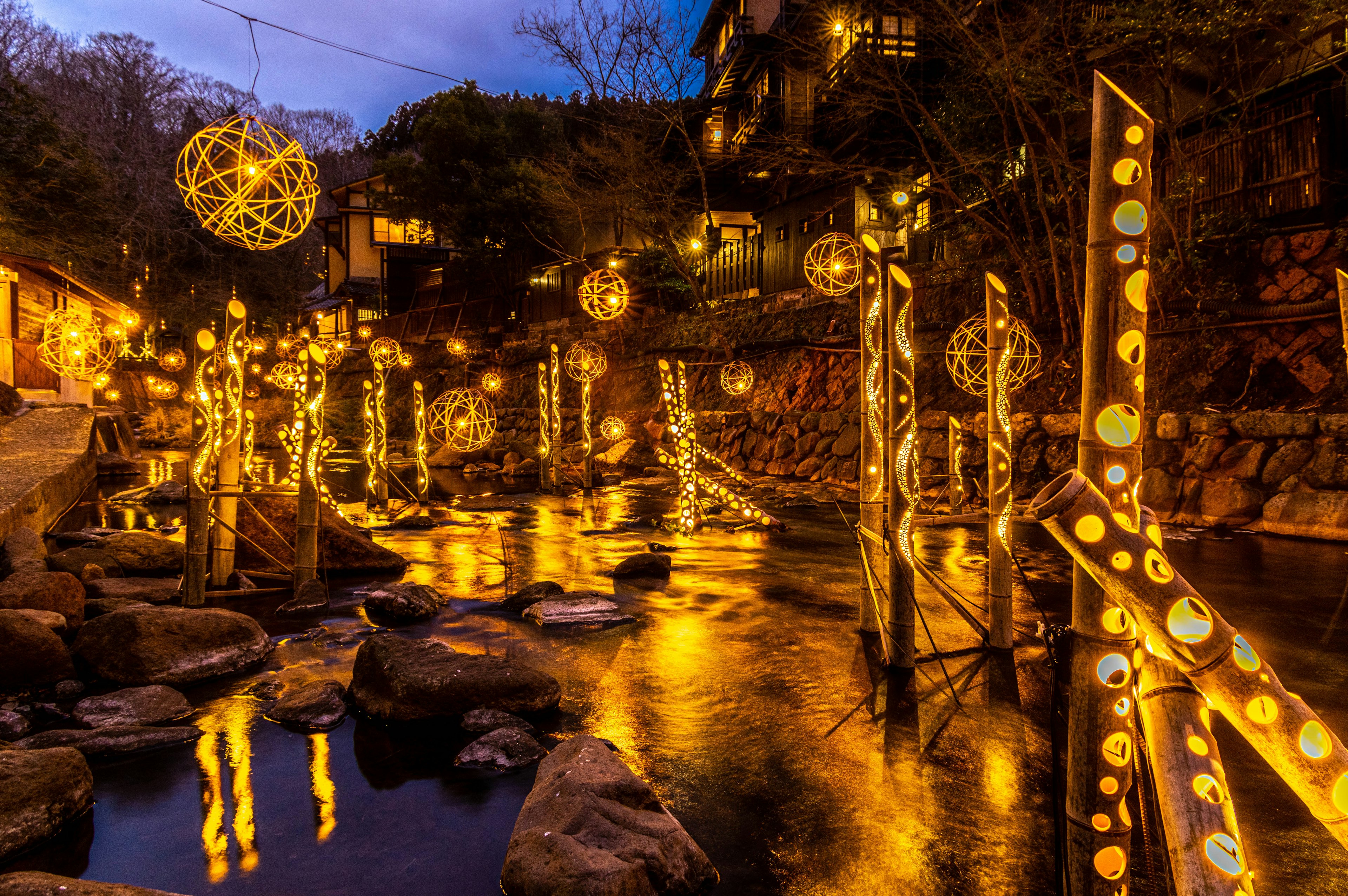 Scenic view of decorative lights along a river at night