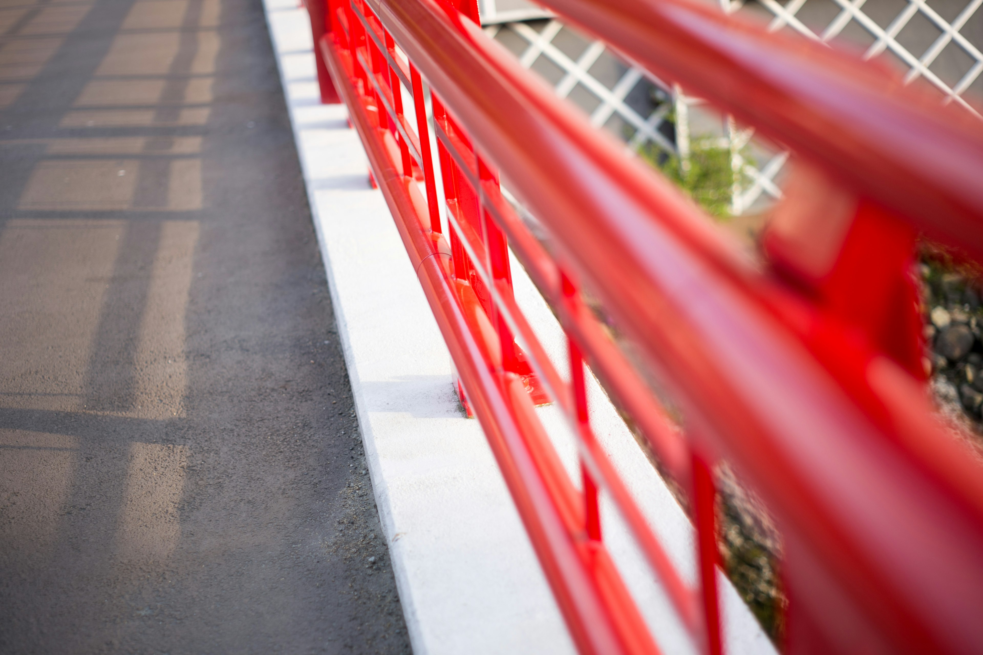 Close-up of a bridge railing in vibrant red