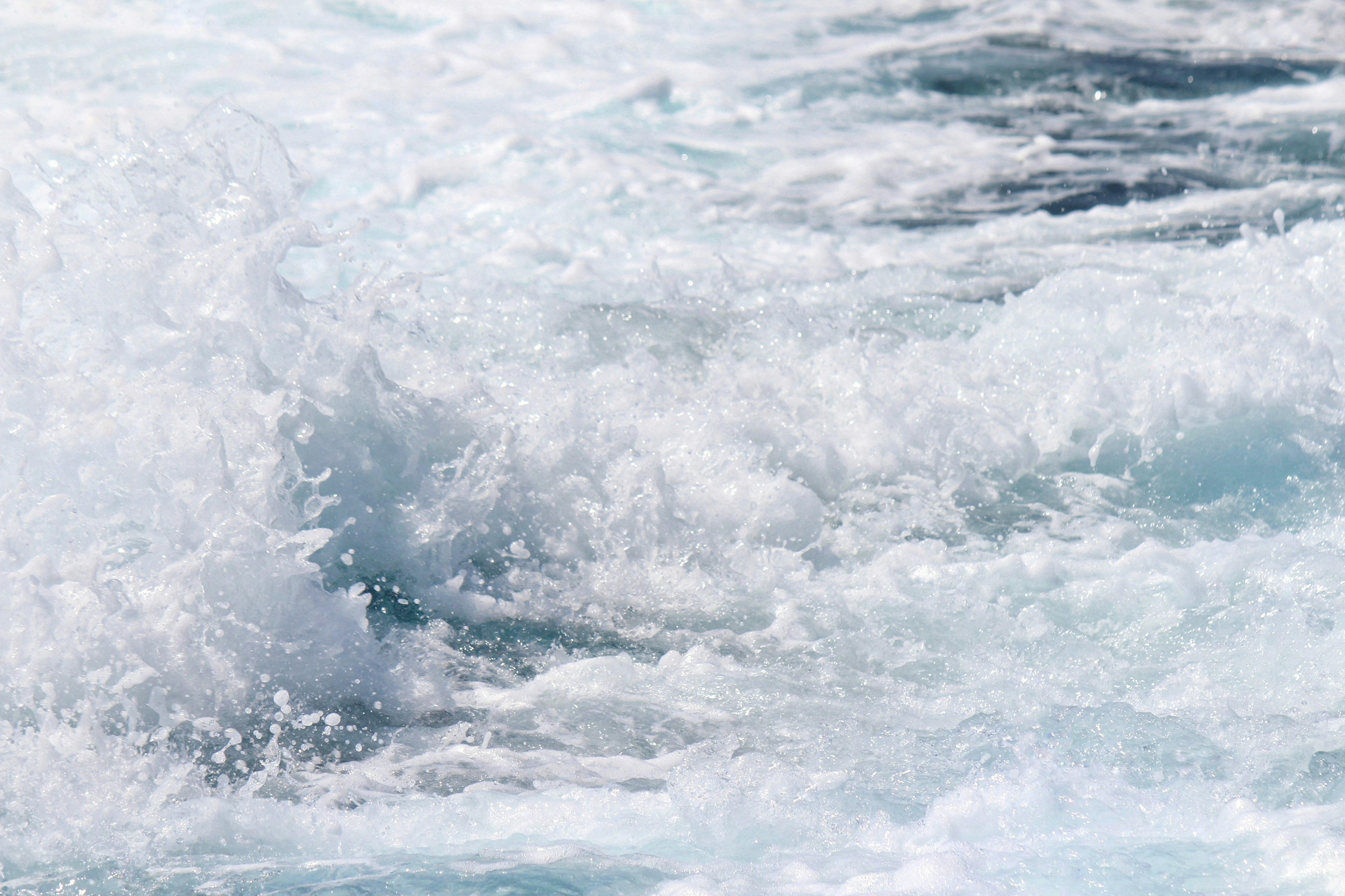 Image capturing the white foamy waves of the ocean