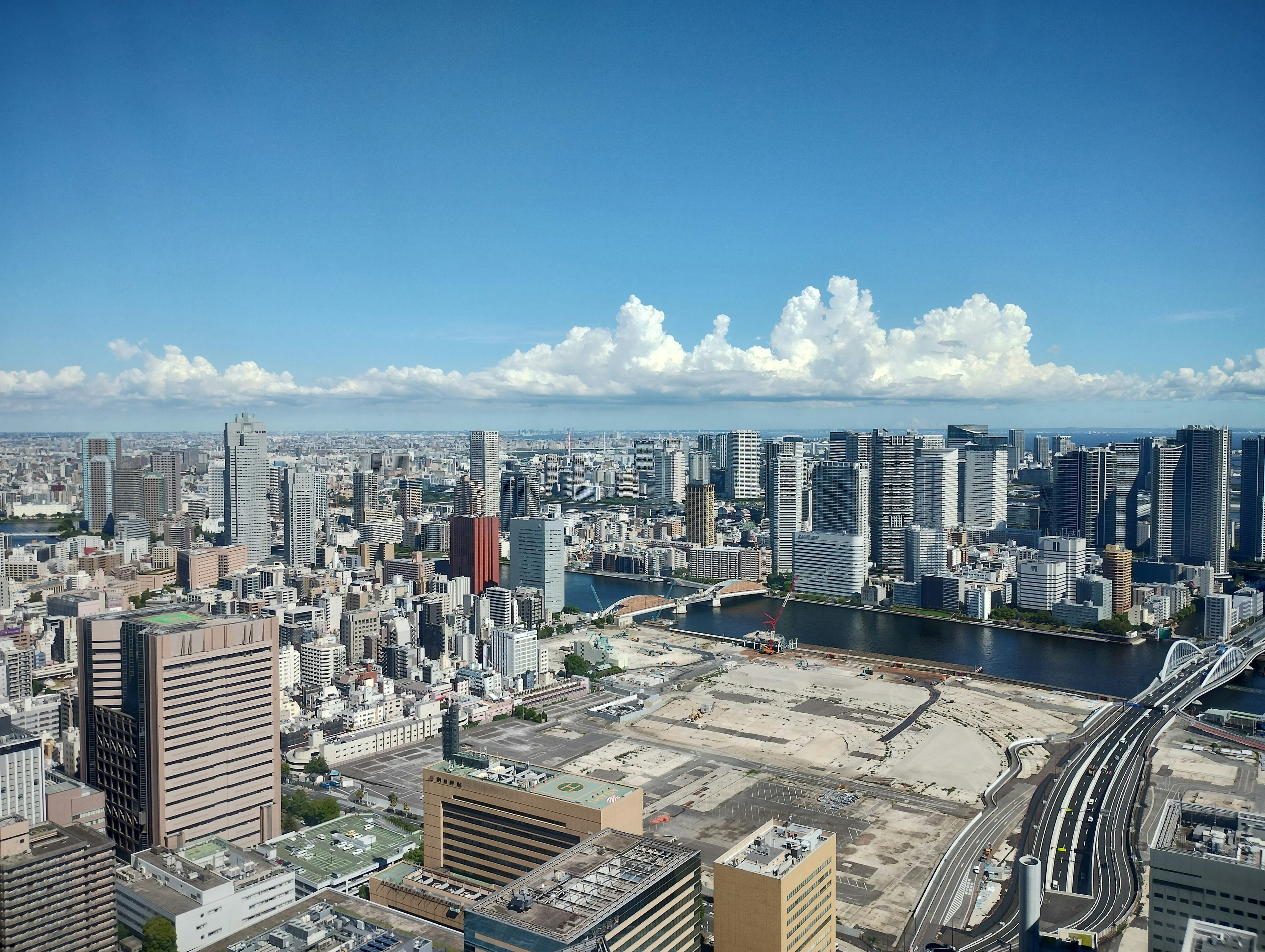 Aerial view of Tokyo skyline with skyscrapers and blue sky