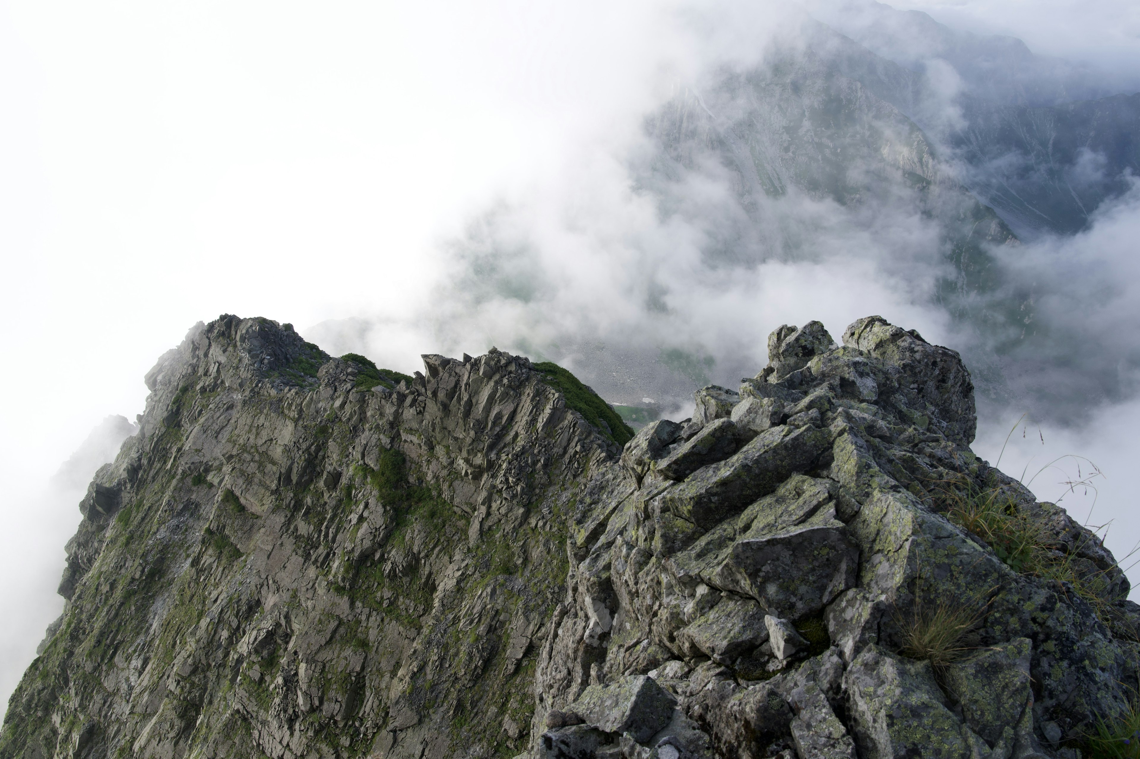 雲に覆われた山の頂上の岩場の風景