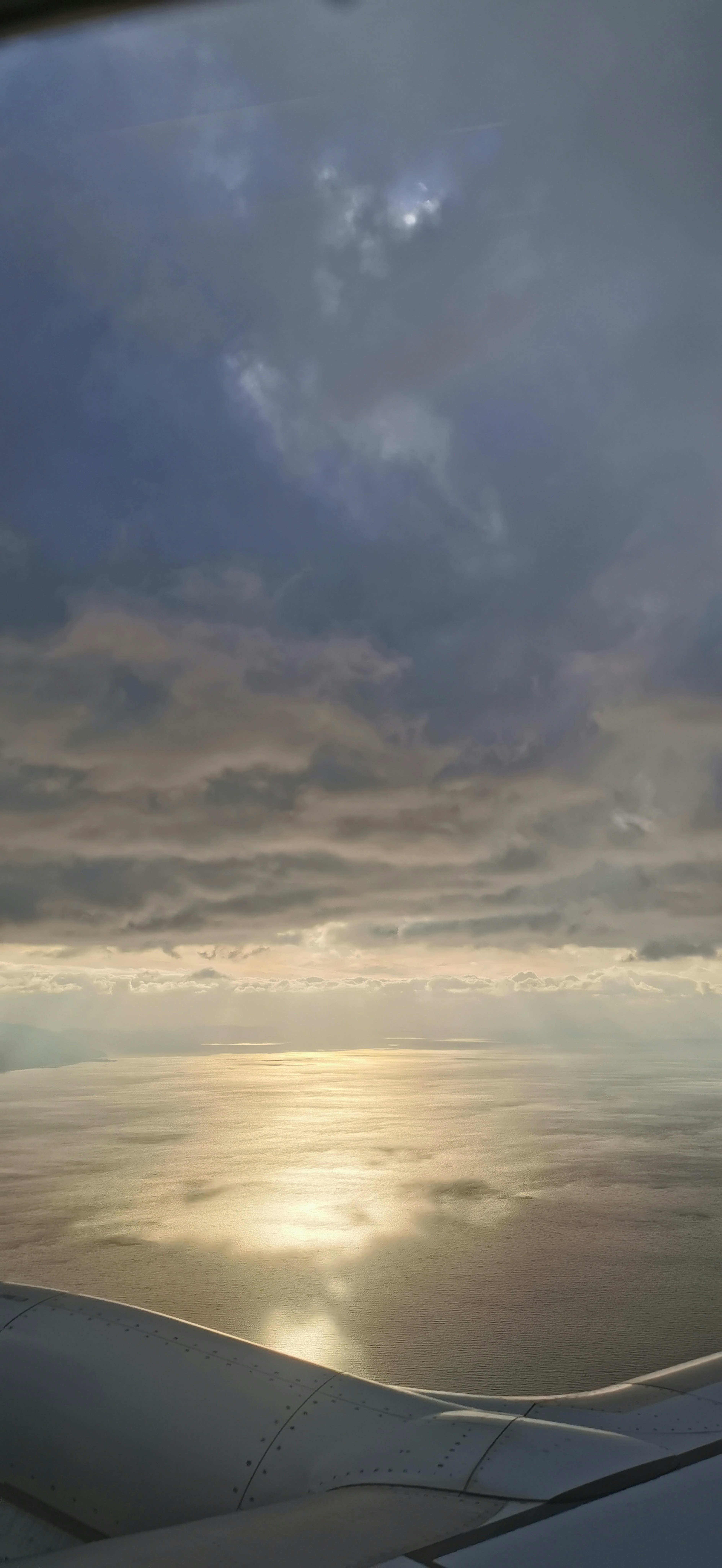 Aerial view of clouds and ocean reflection