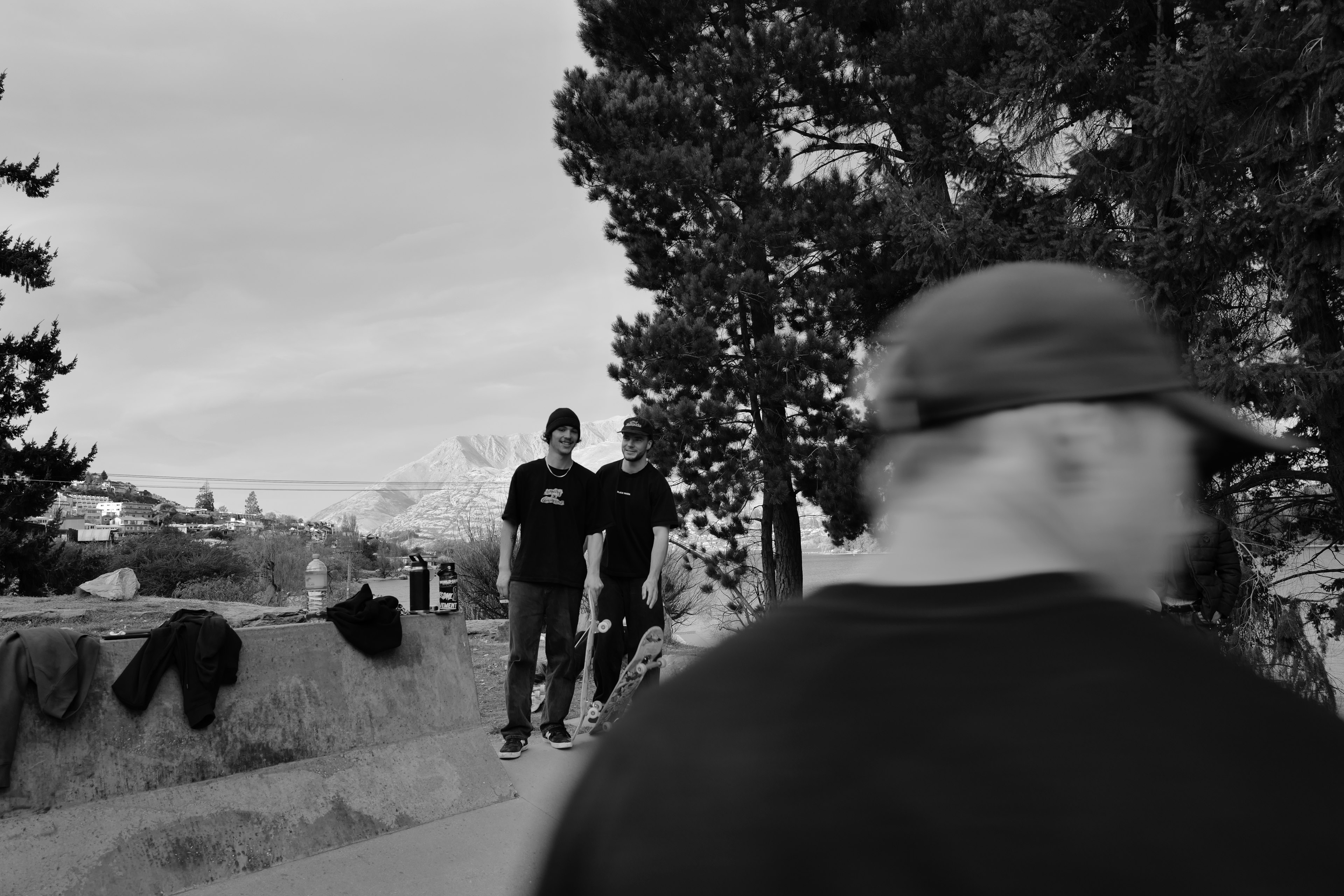 Black and white scene featuring two people standing among trees