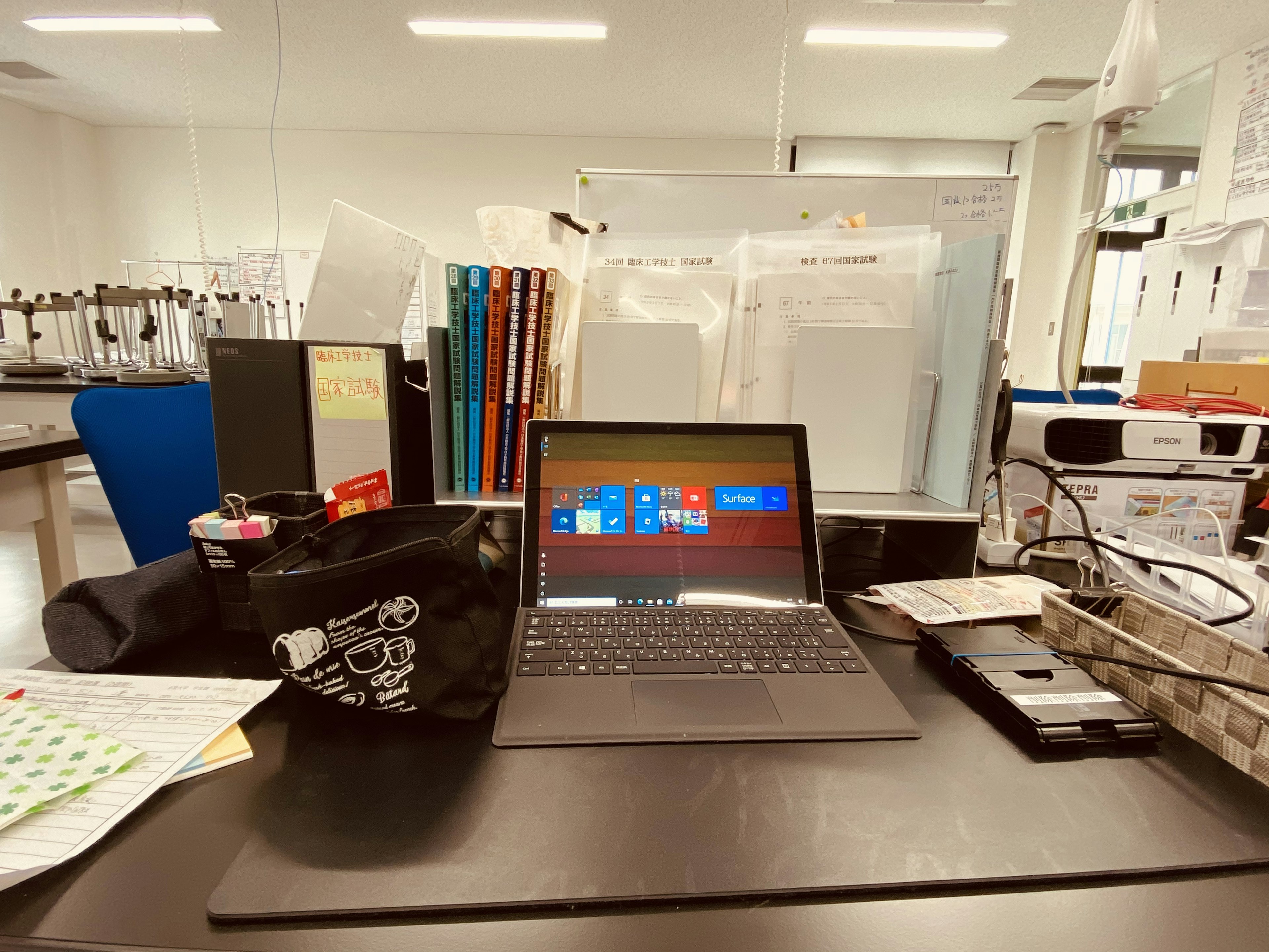 Office scene with a tablet on the desk surrounded by documents and stationery