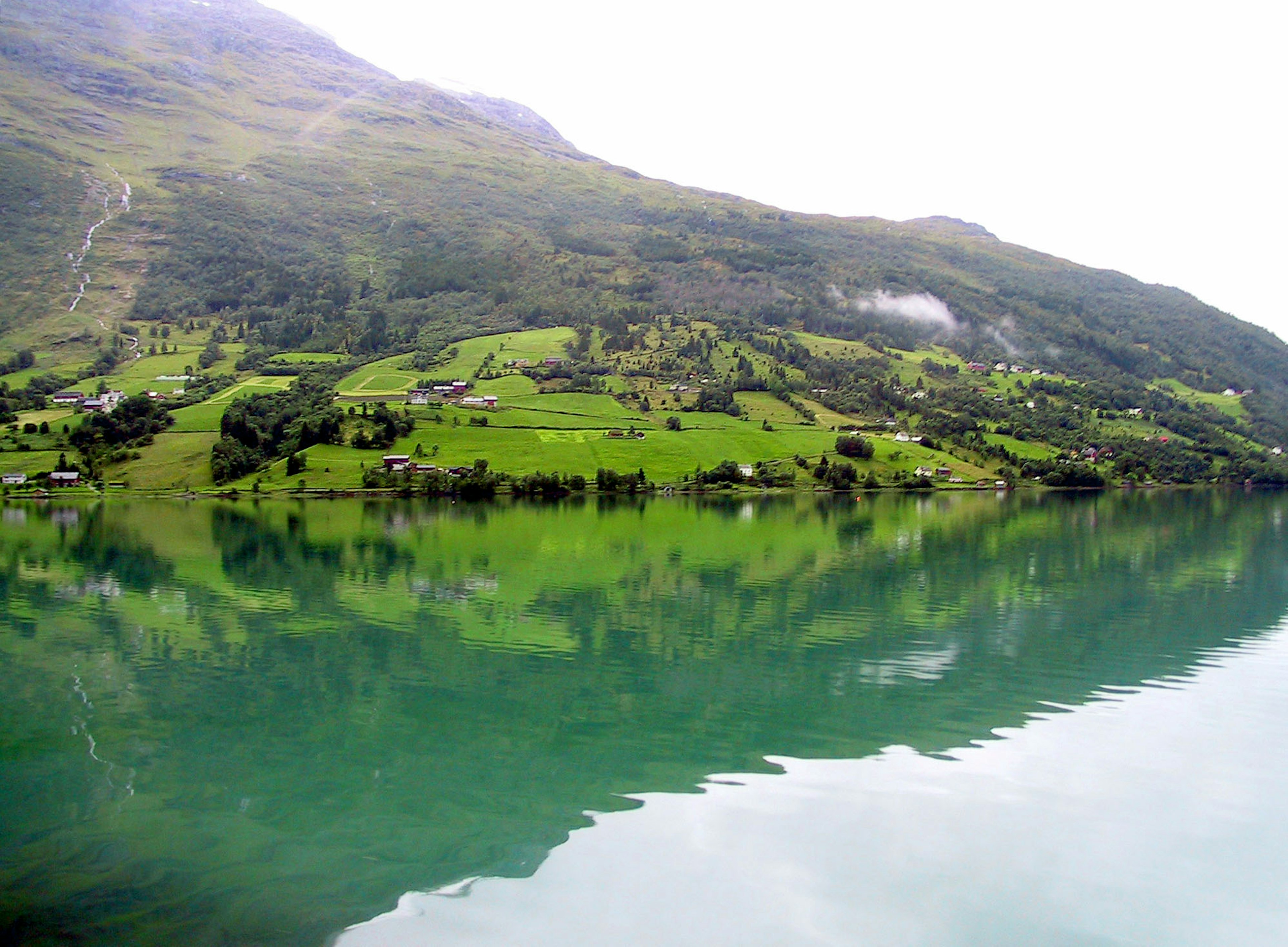 Beautiful landscape of lush green mountains and reflections on water