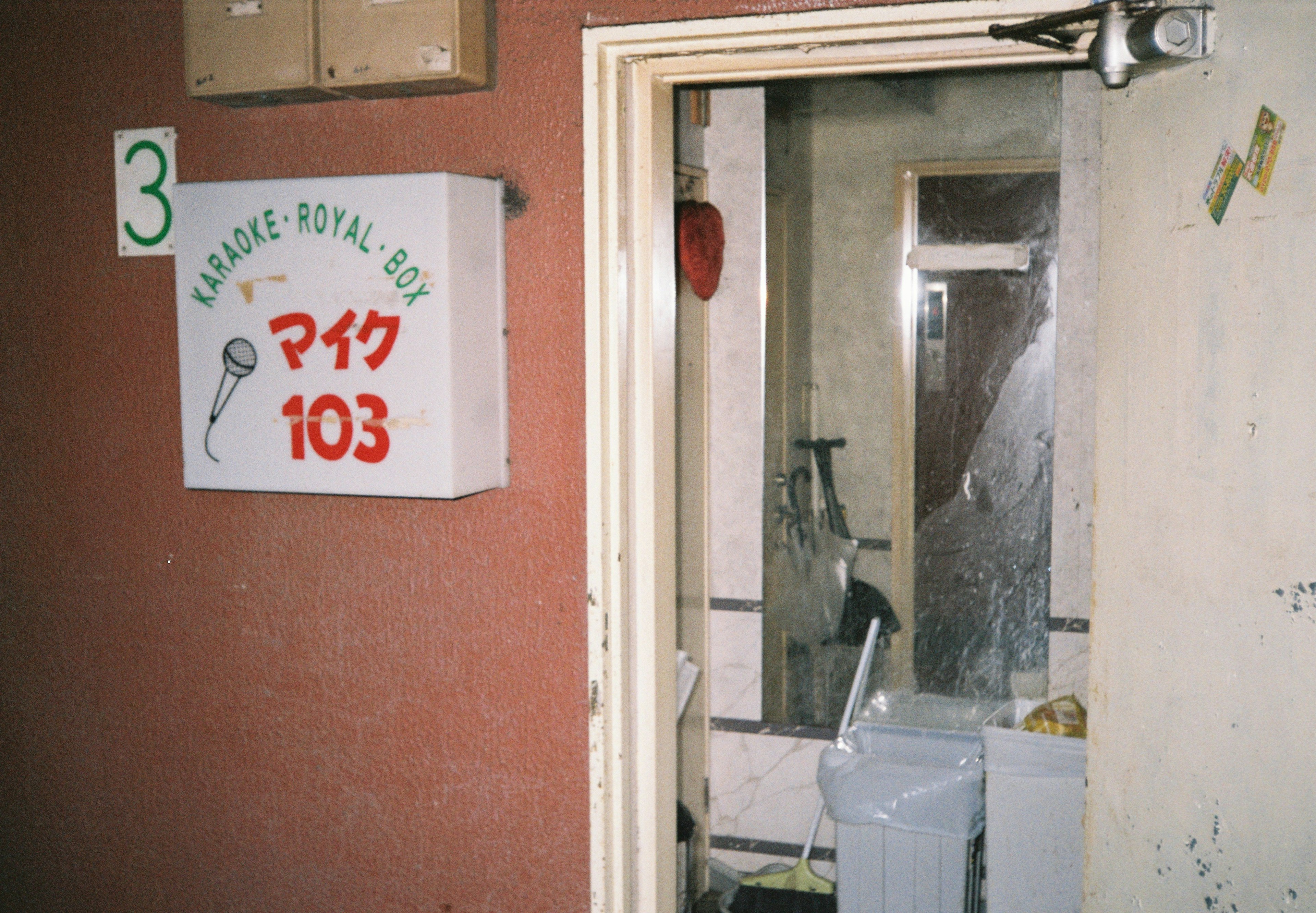 Entrance to room 103 with a sign and worn door