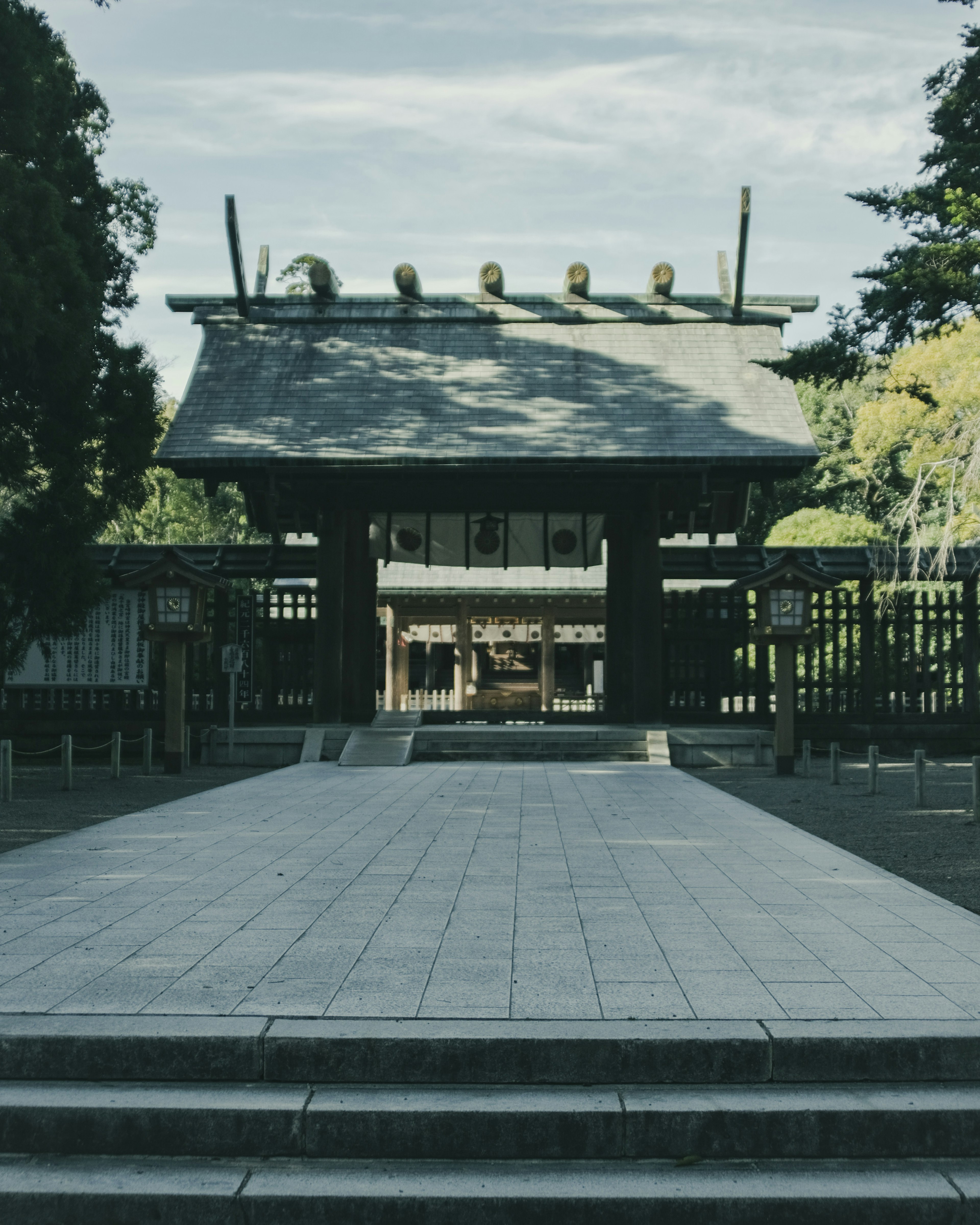 Stone steps leading to the entrance of a shrine with a large gate