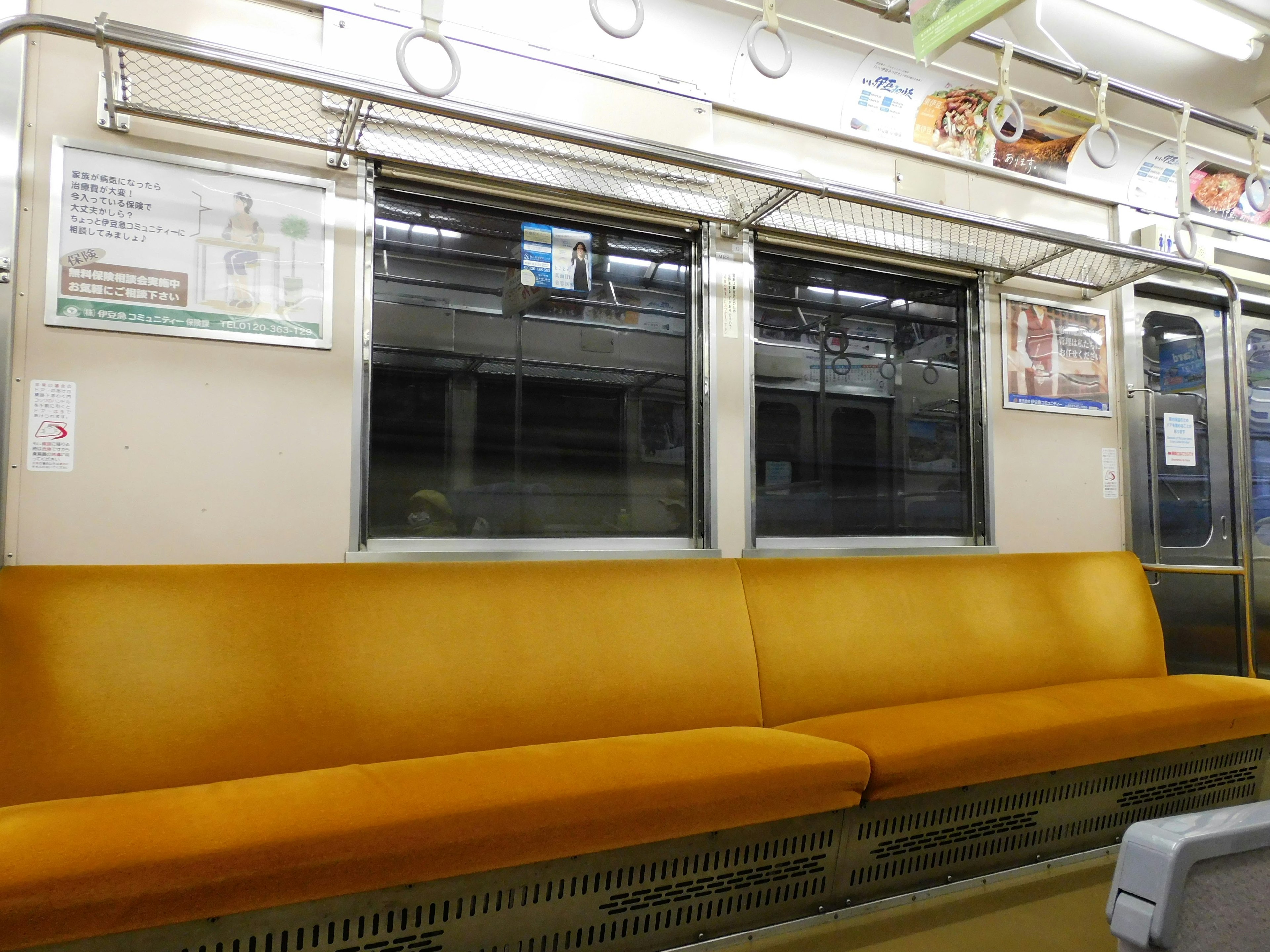 Interior of a subway train featuring orange seating