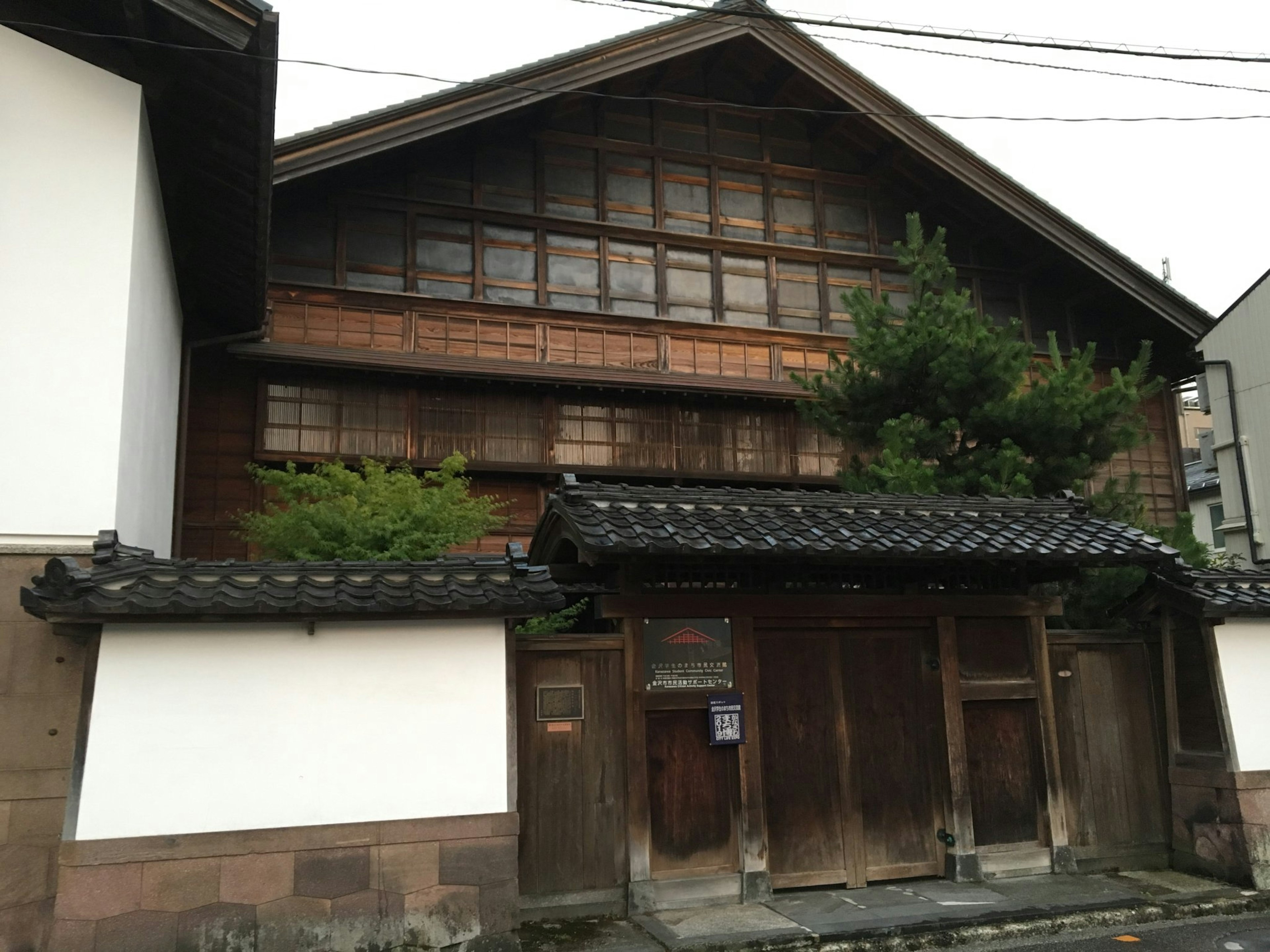 Traditional wooden Japanese house exterior featuring old wood and detailed windows