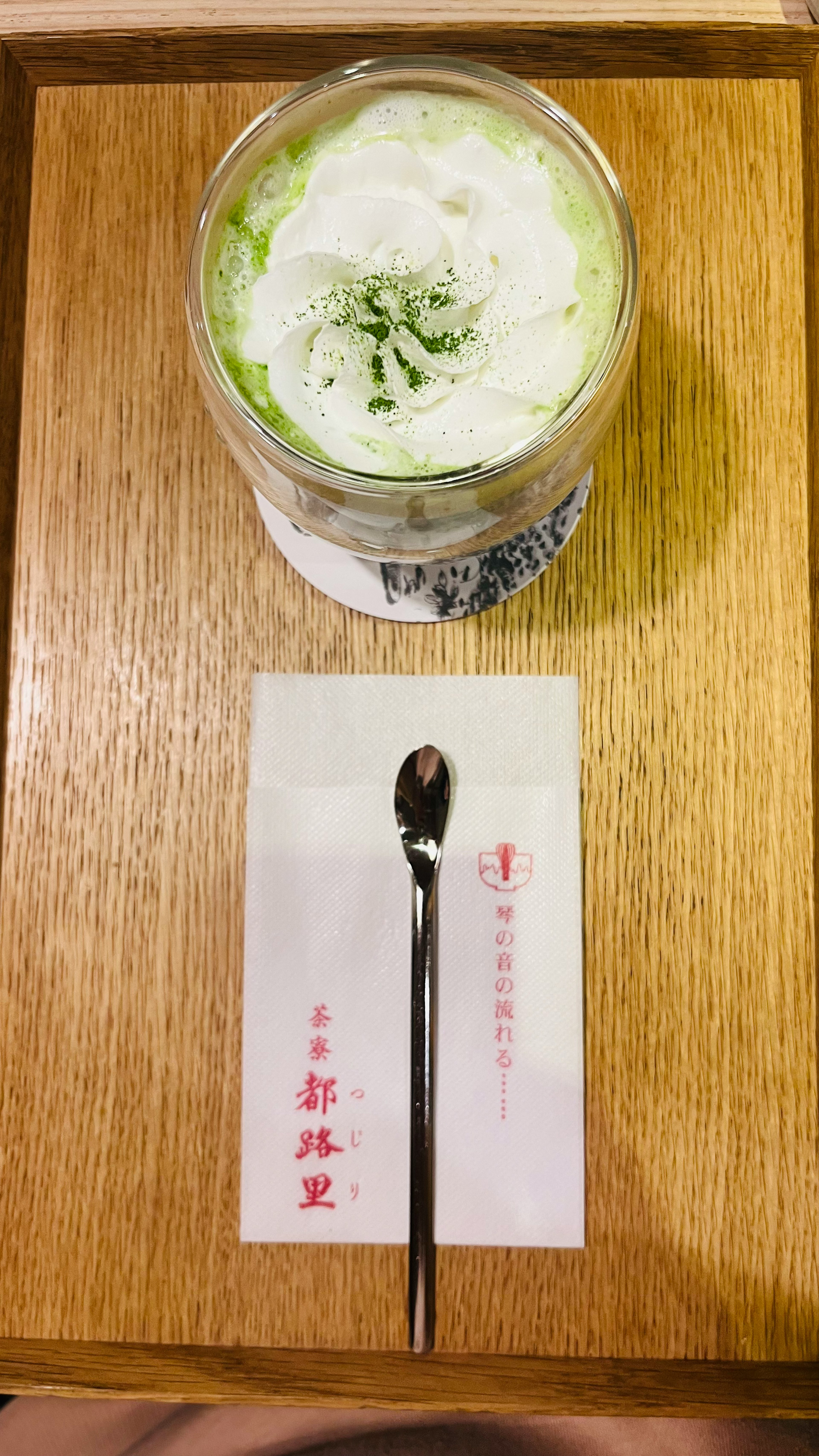 A beautiful matcha dessert placed on a wooden tray