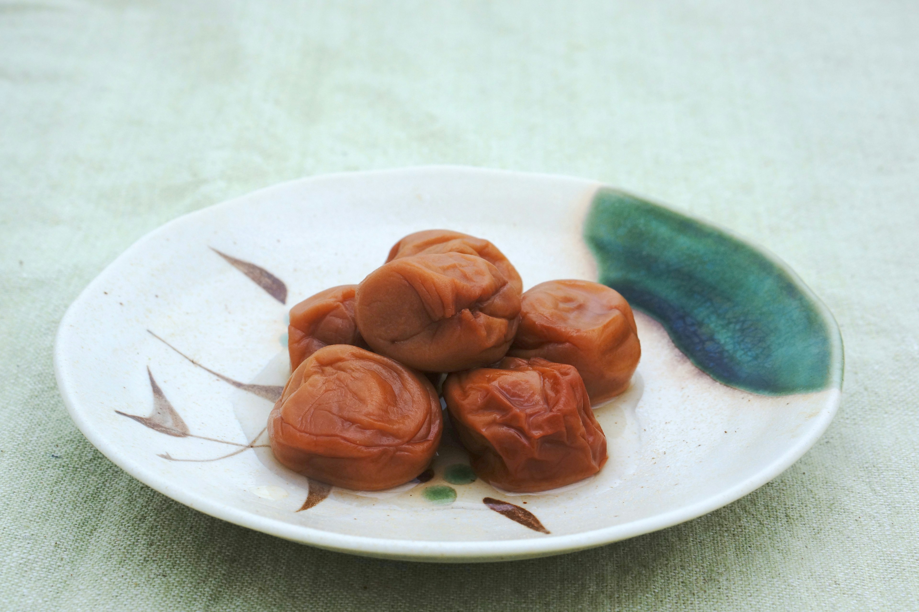 Sweet preserved plums arranged on a decorative plate