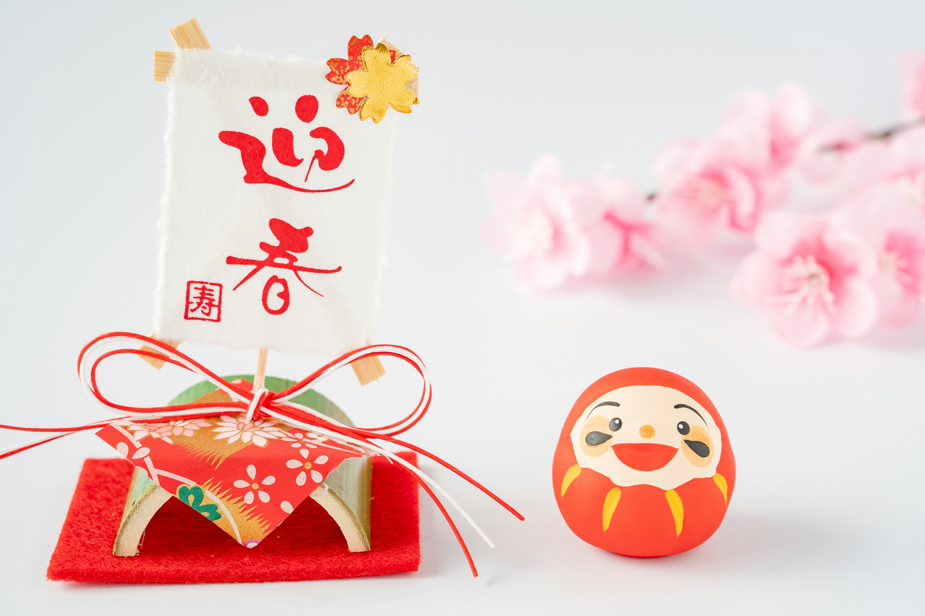 Japanese New Year decoration with red accents and cherry blossoms