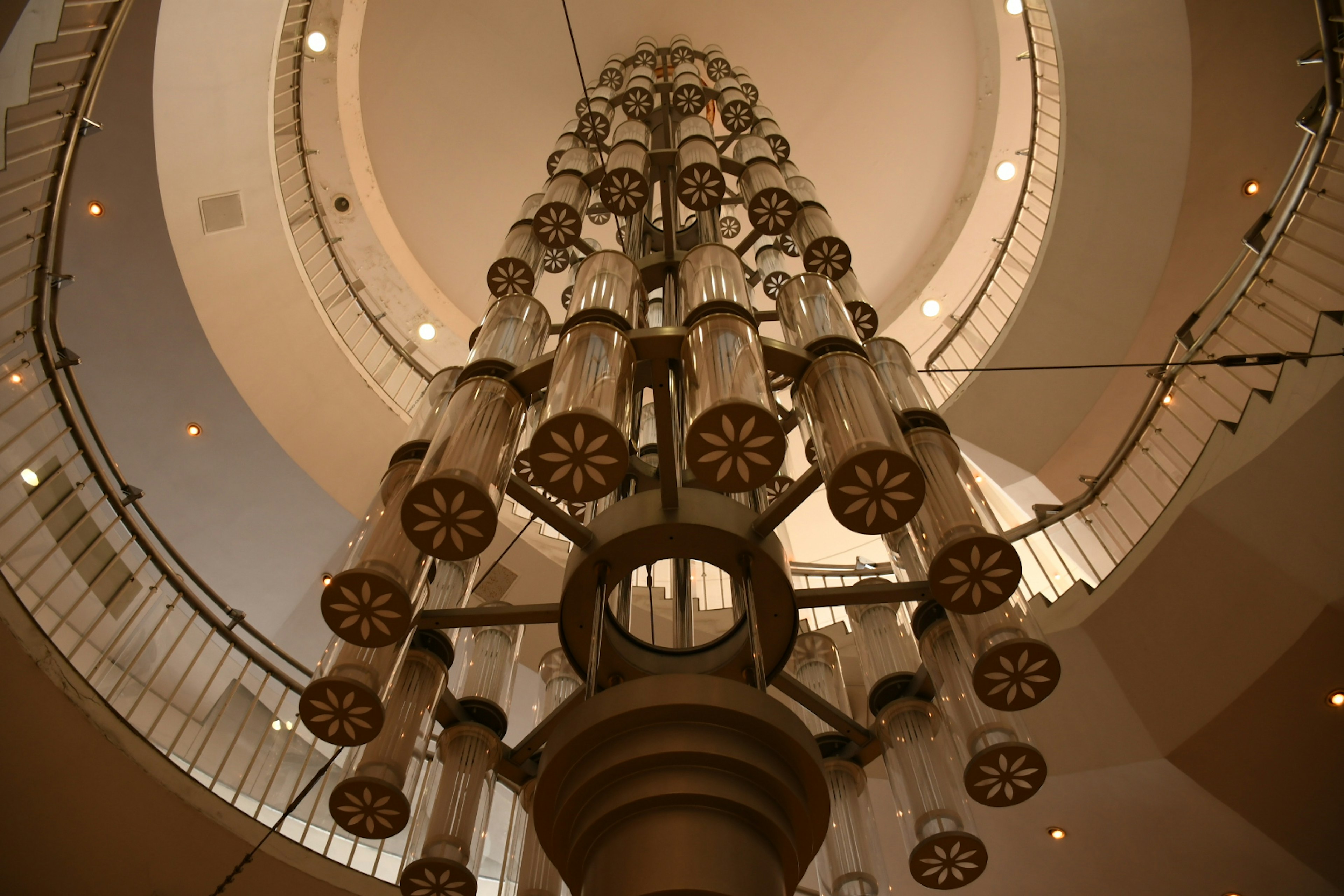 A stunning chandelier viewed from below in a spiral staircase setting