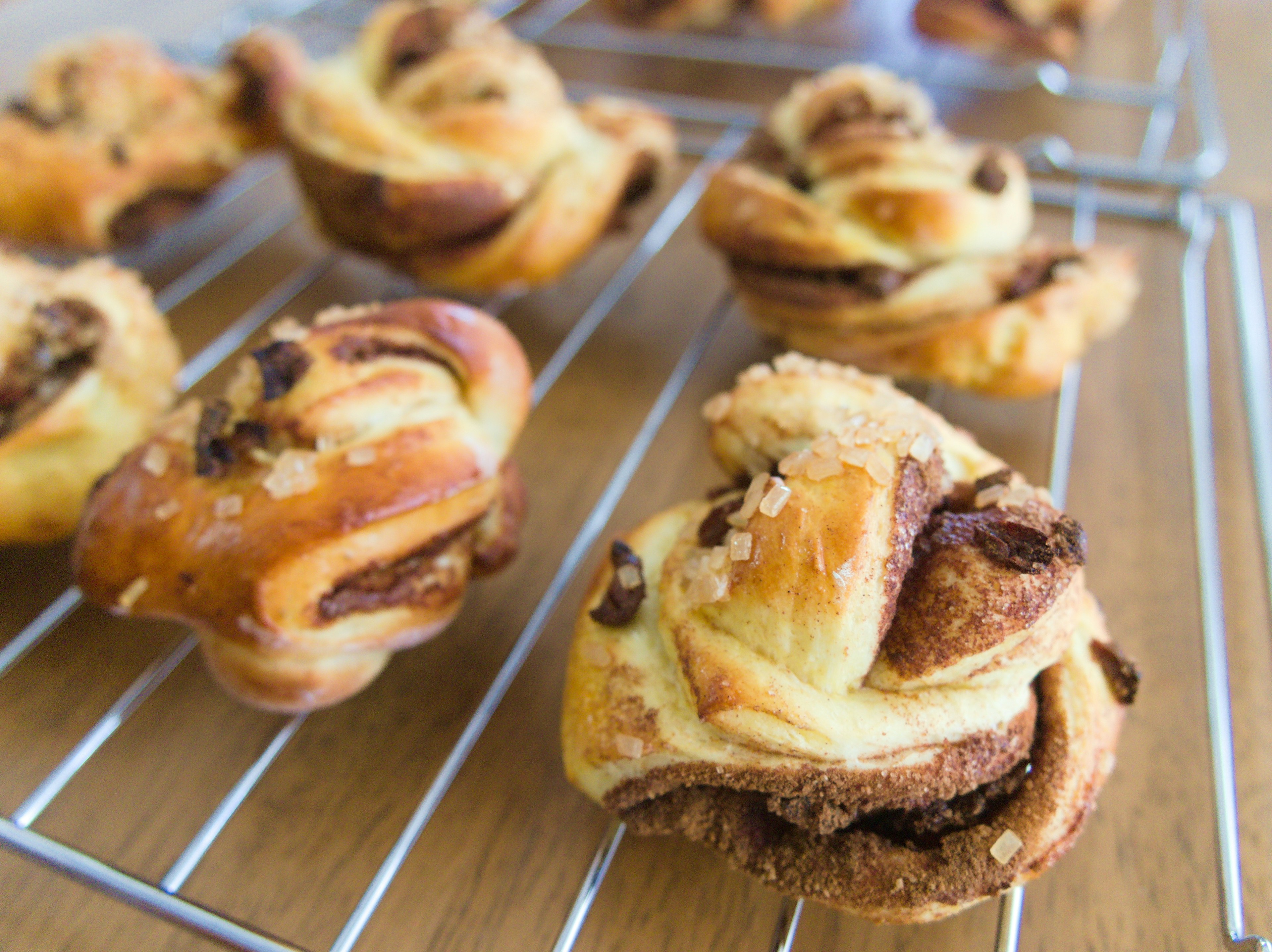 Freshly baked cinnamon rolls arranged on a wire rack