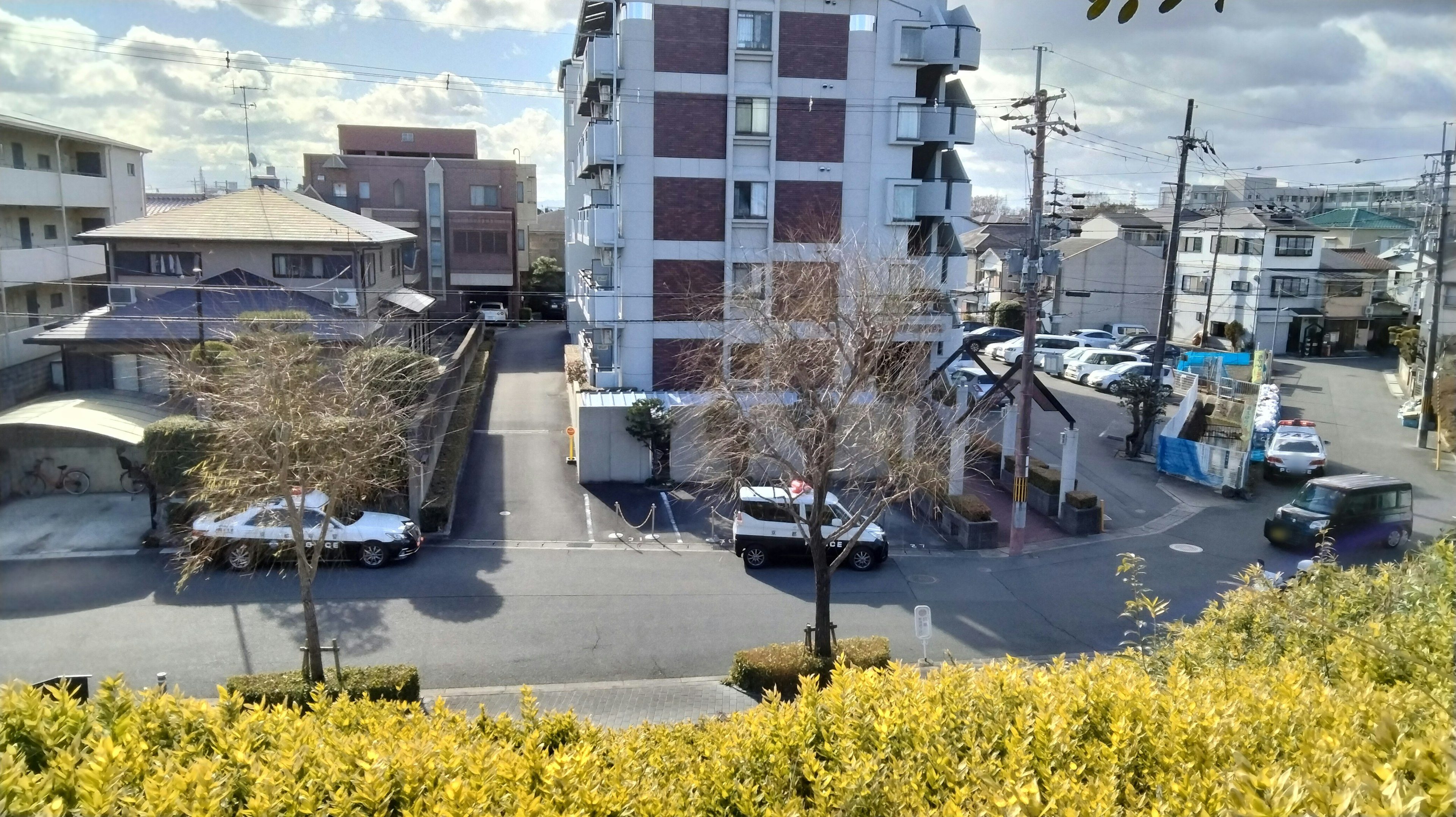 Urban landscape with apartment buildings and parking lot under blue sky