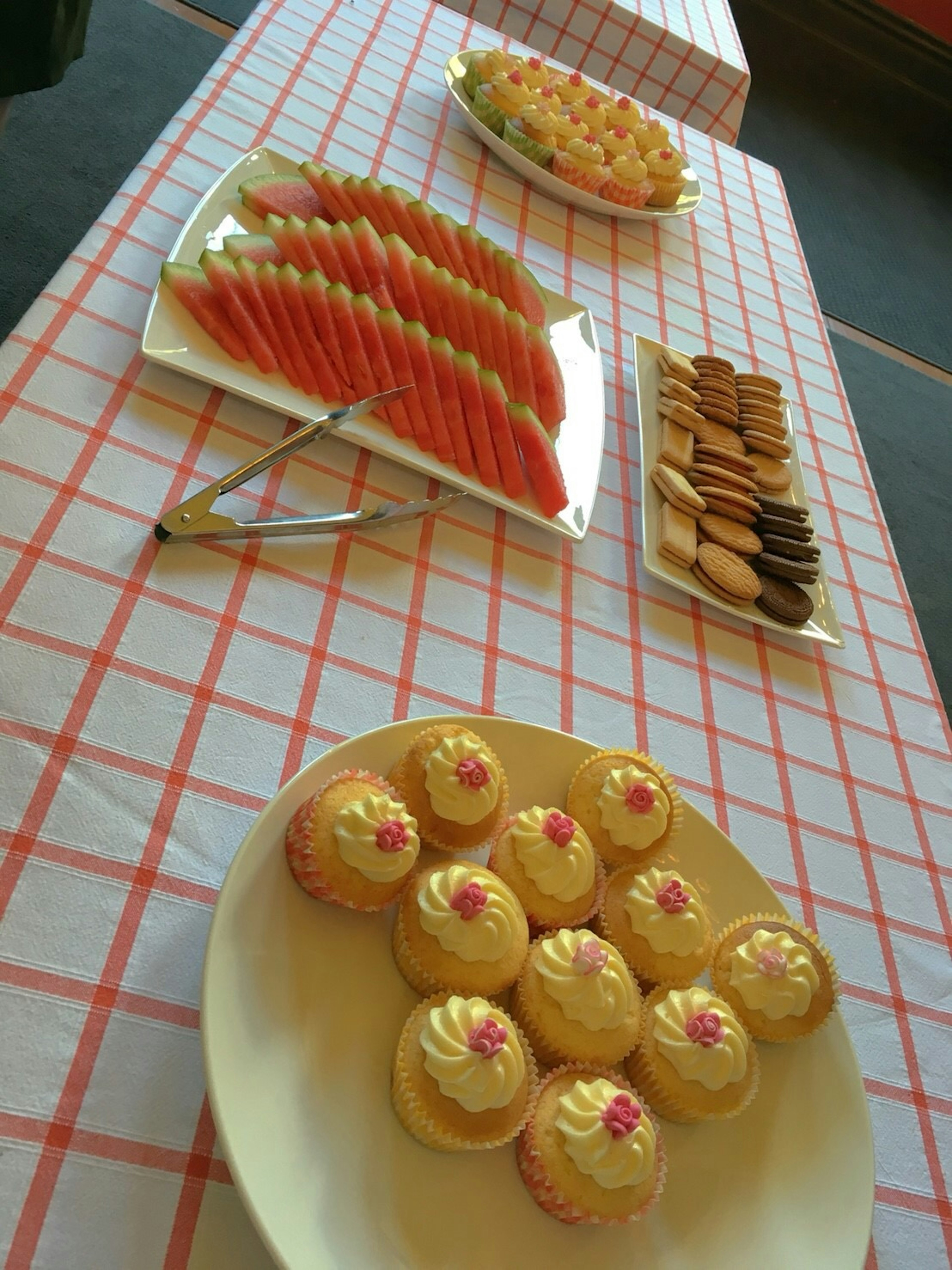 A table displaying an arrangement of cupcakes and sweets