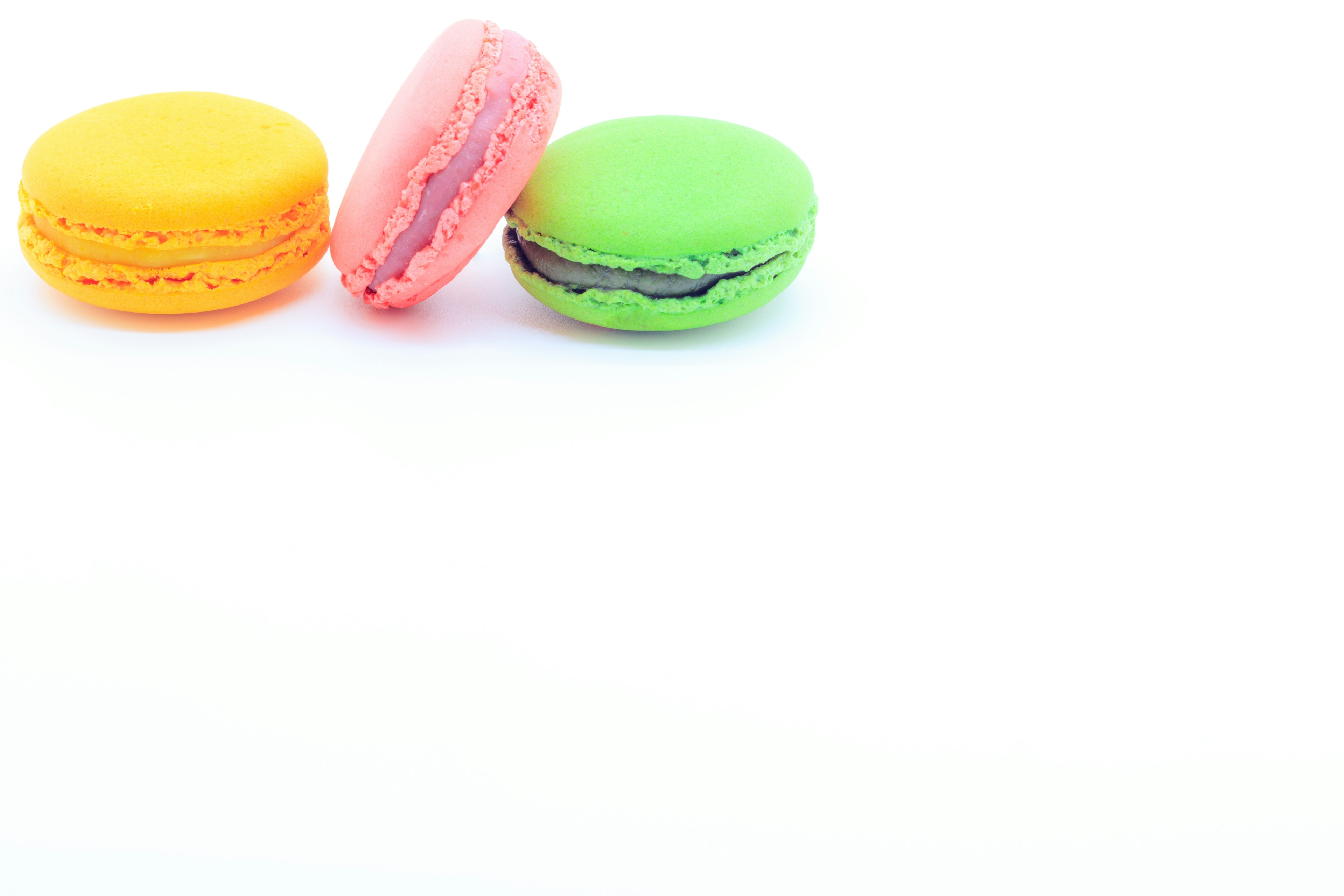 Colorful macarons in yellow pink and green