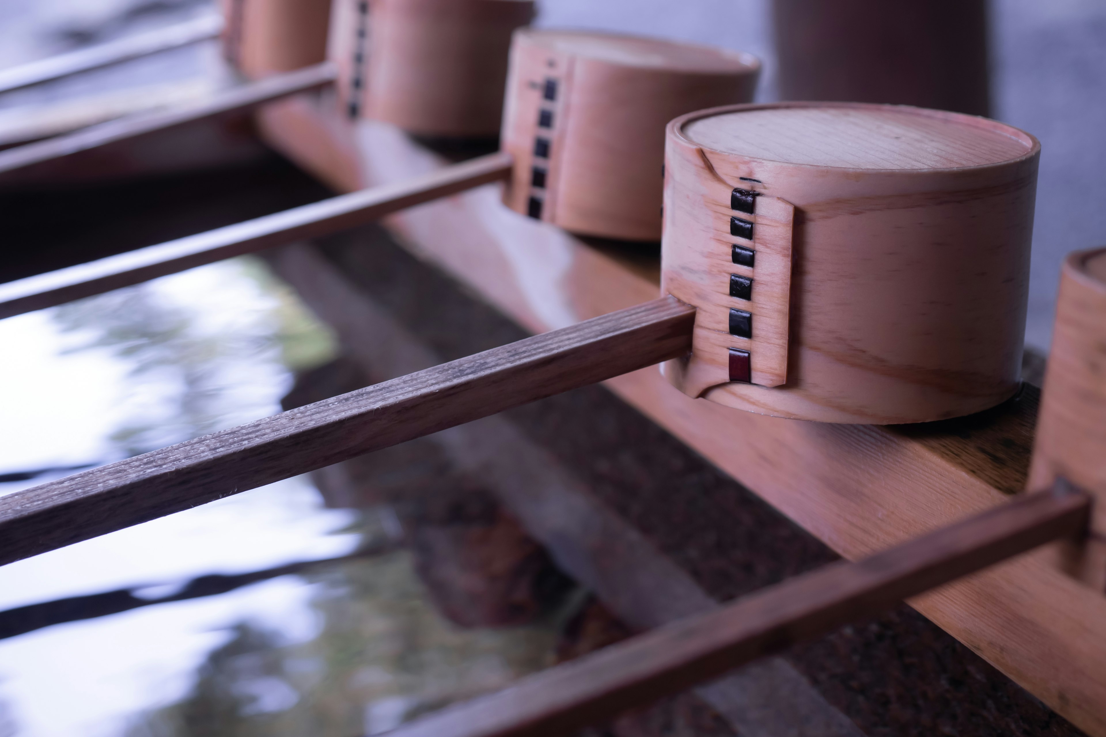 Wooden scoops with long handles arranged near water