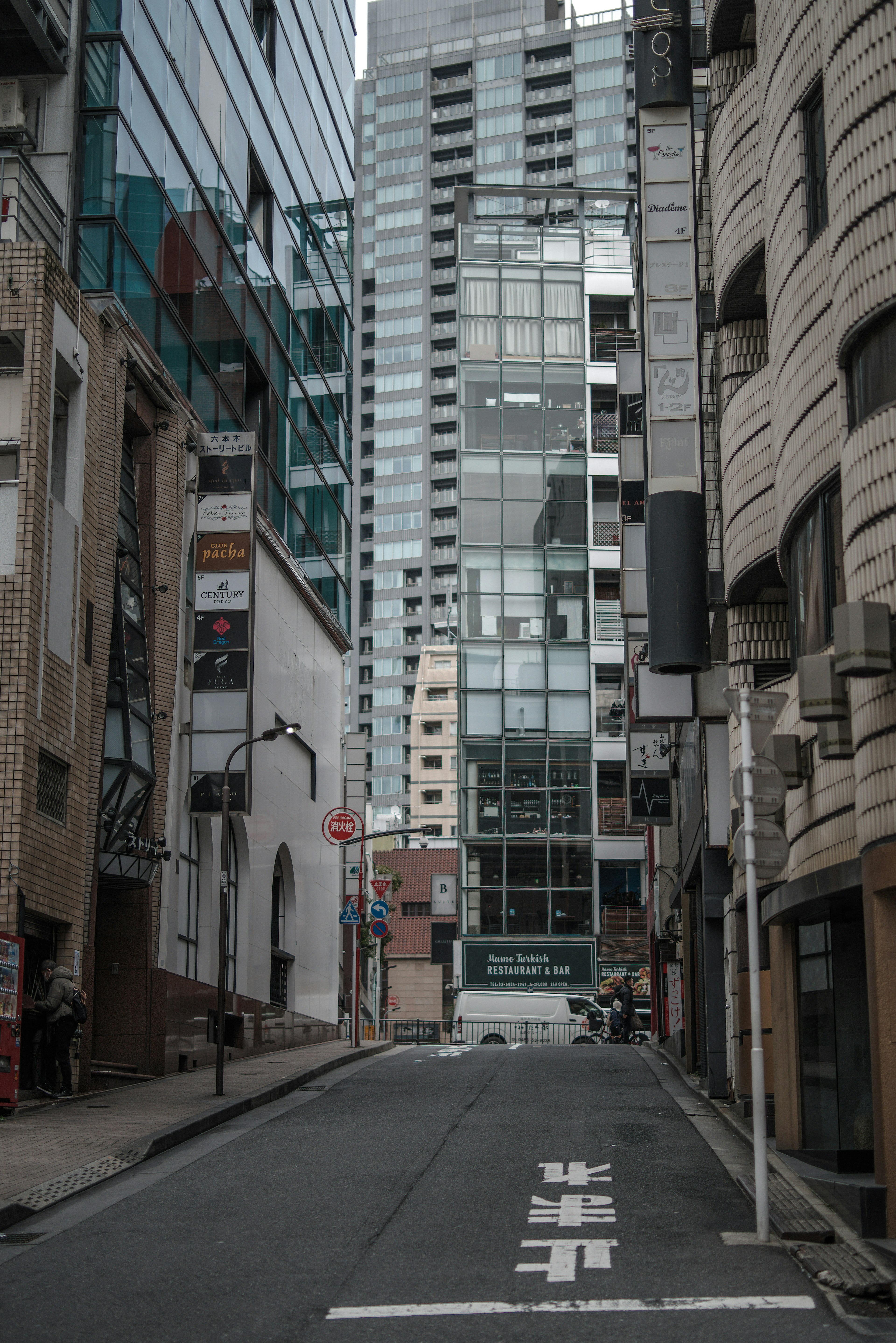 Narrow street lined with high-rise buildings