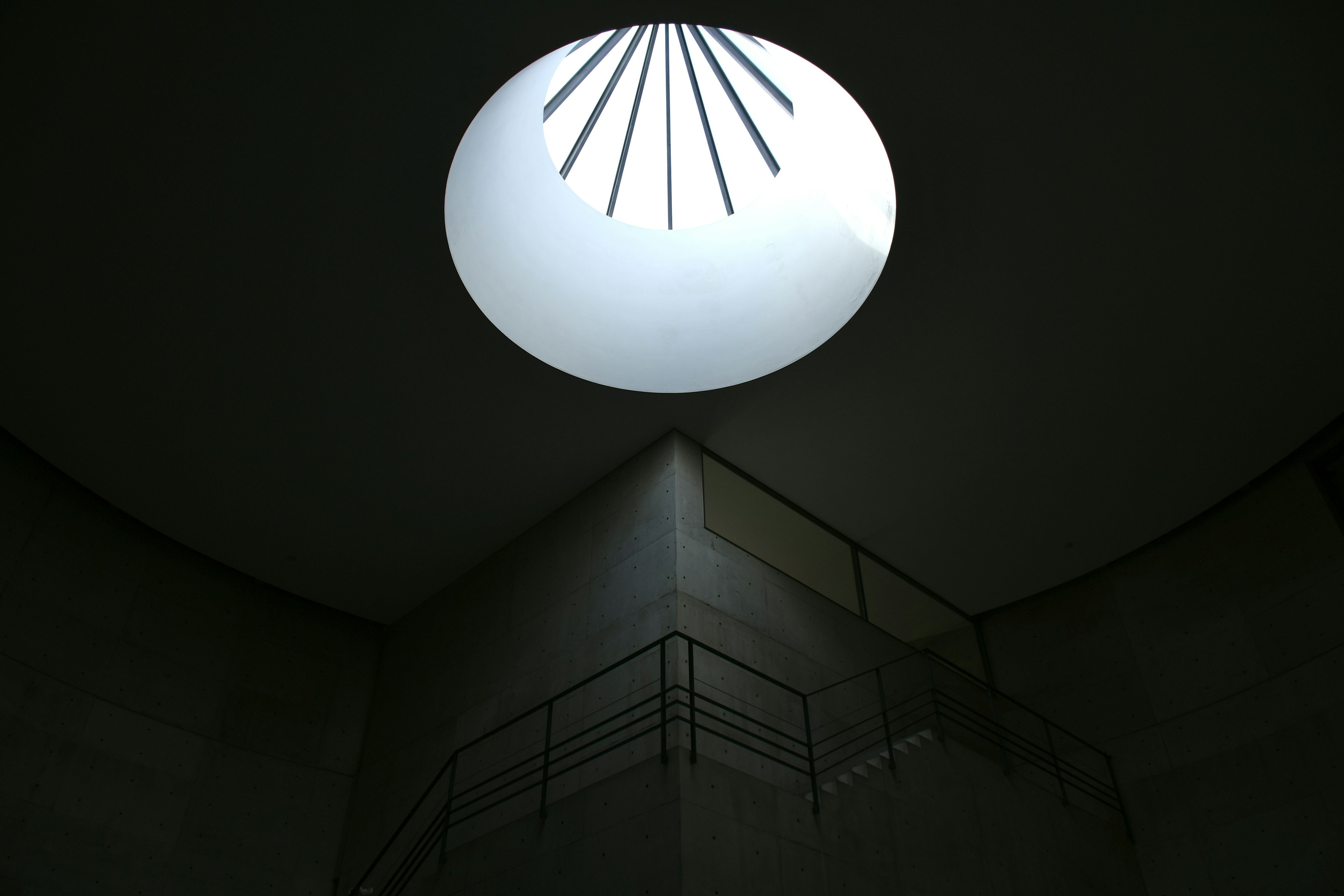 Interior staircase with light coming through a circular skylight