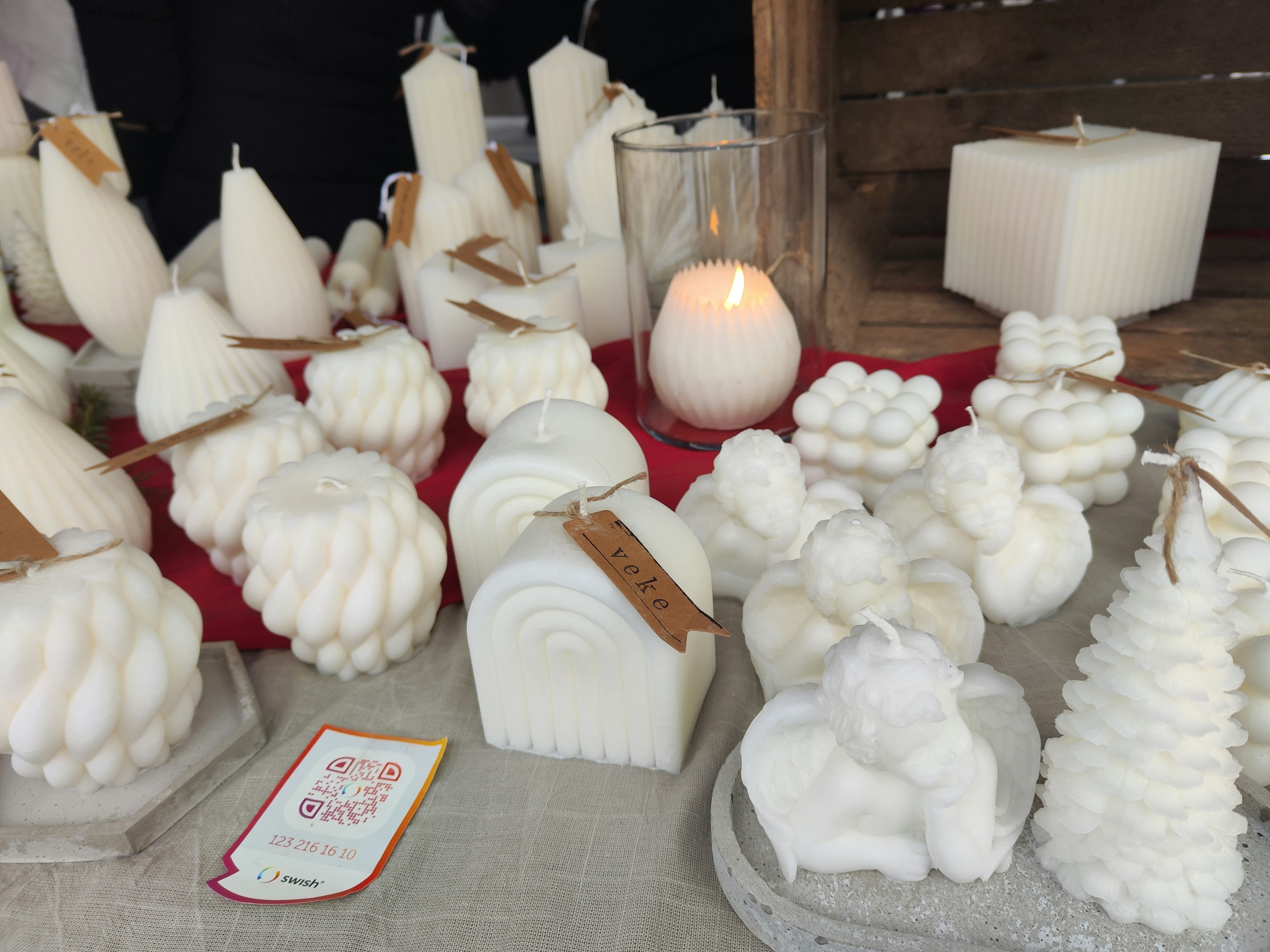 A variety of white candles displayed on a table