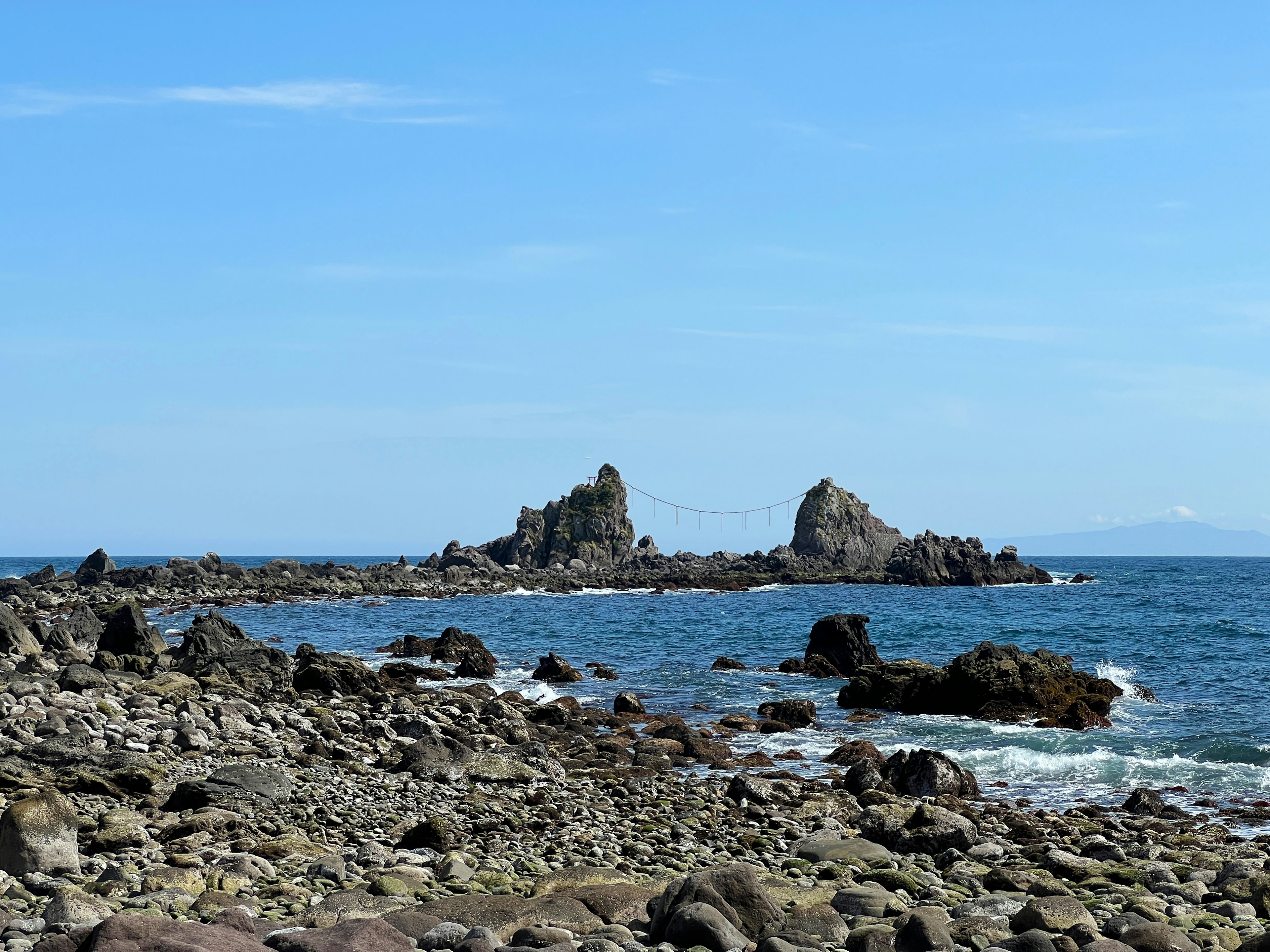 Rocky islands in a clear blue sea under a bright sky