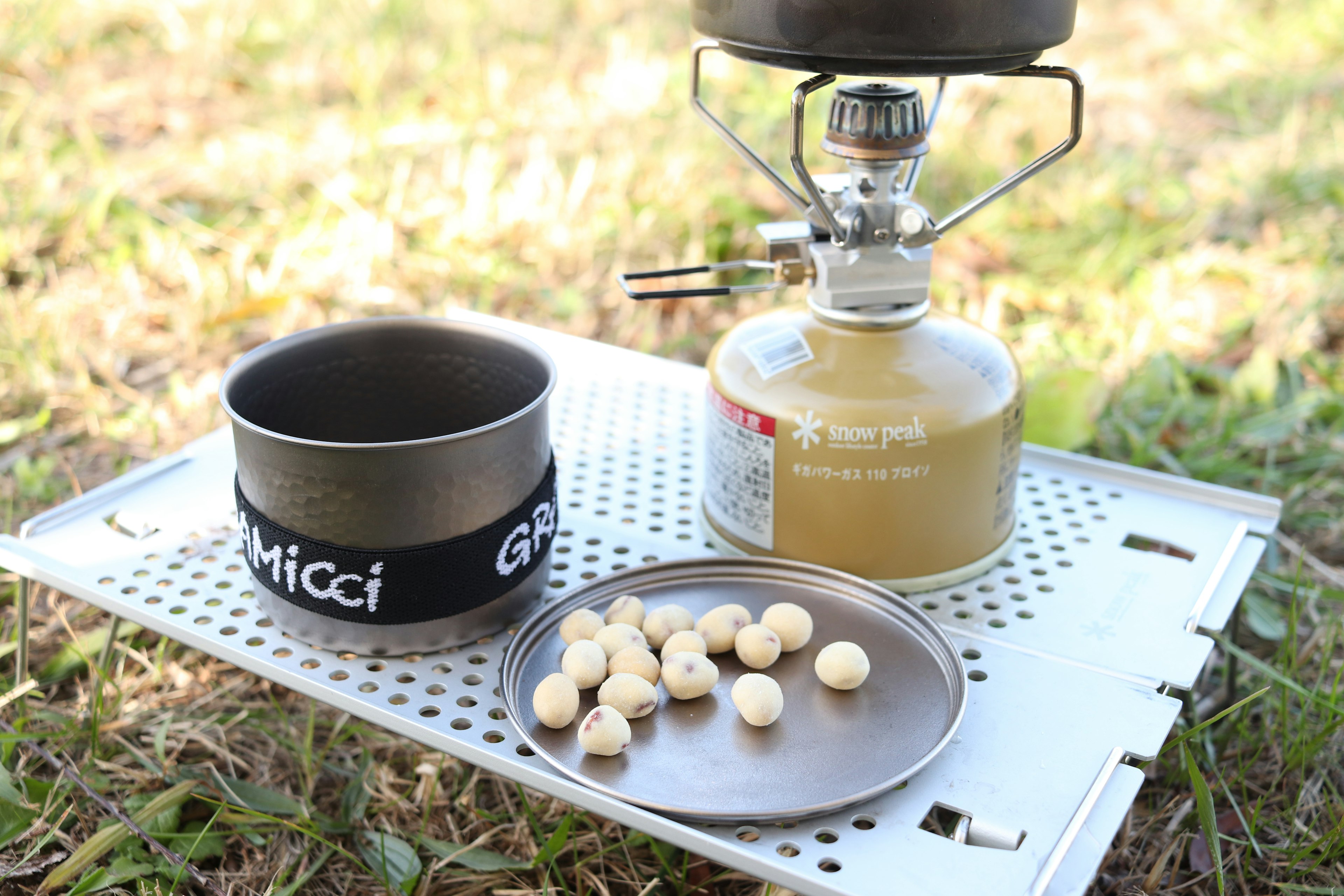 Outdoor gas burner and cooking equipment placed on grass