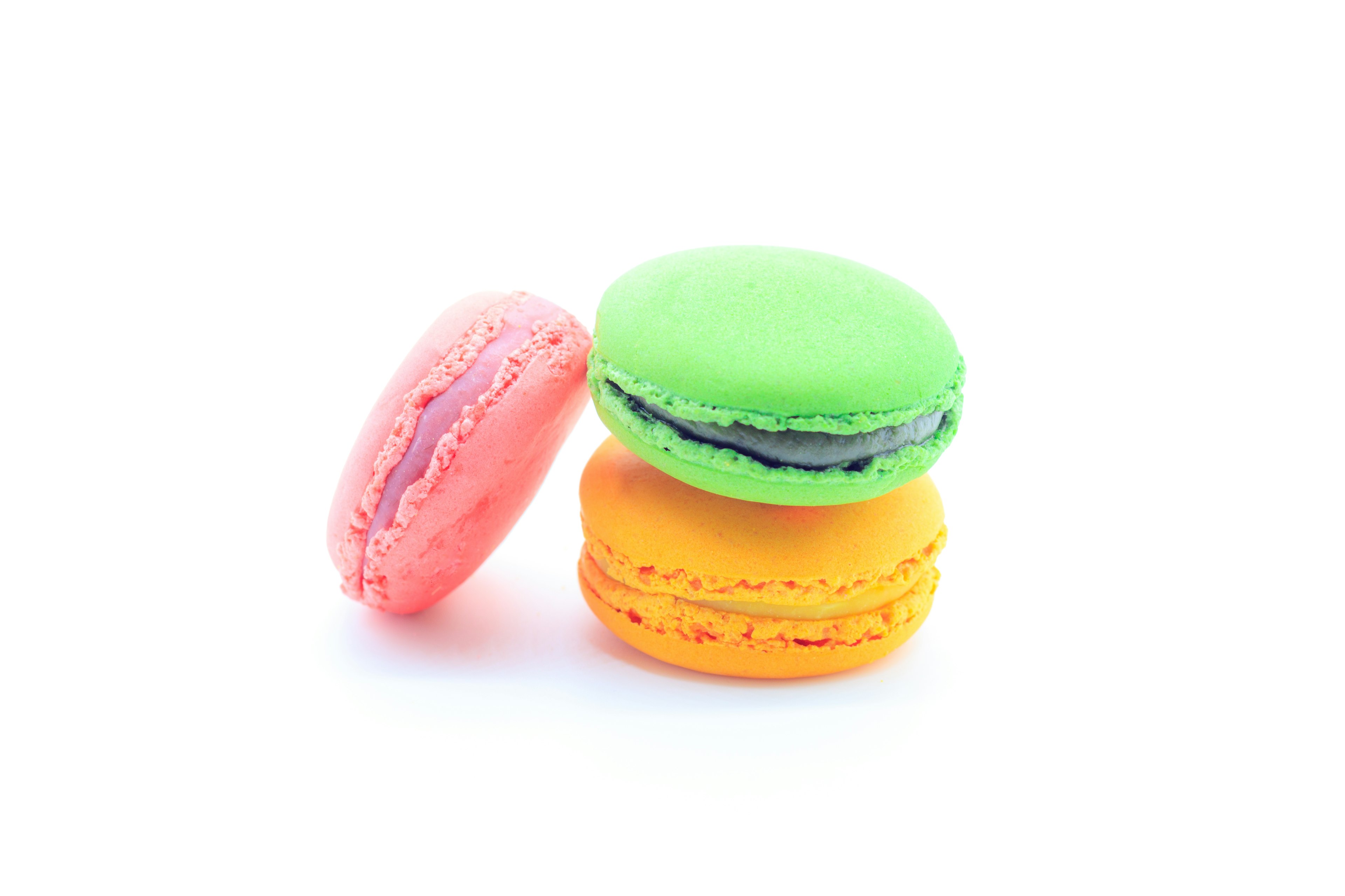 Three colorful macarons stacked with vibrant colors